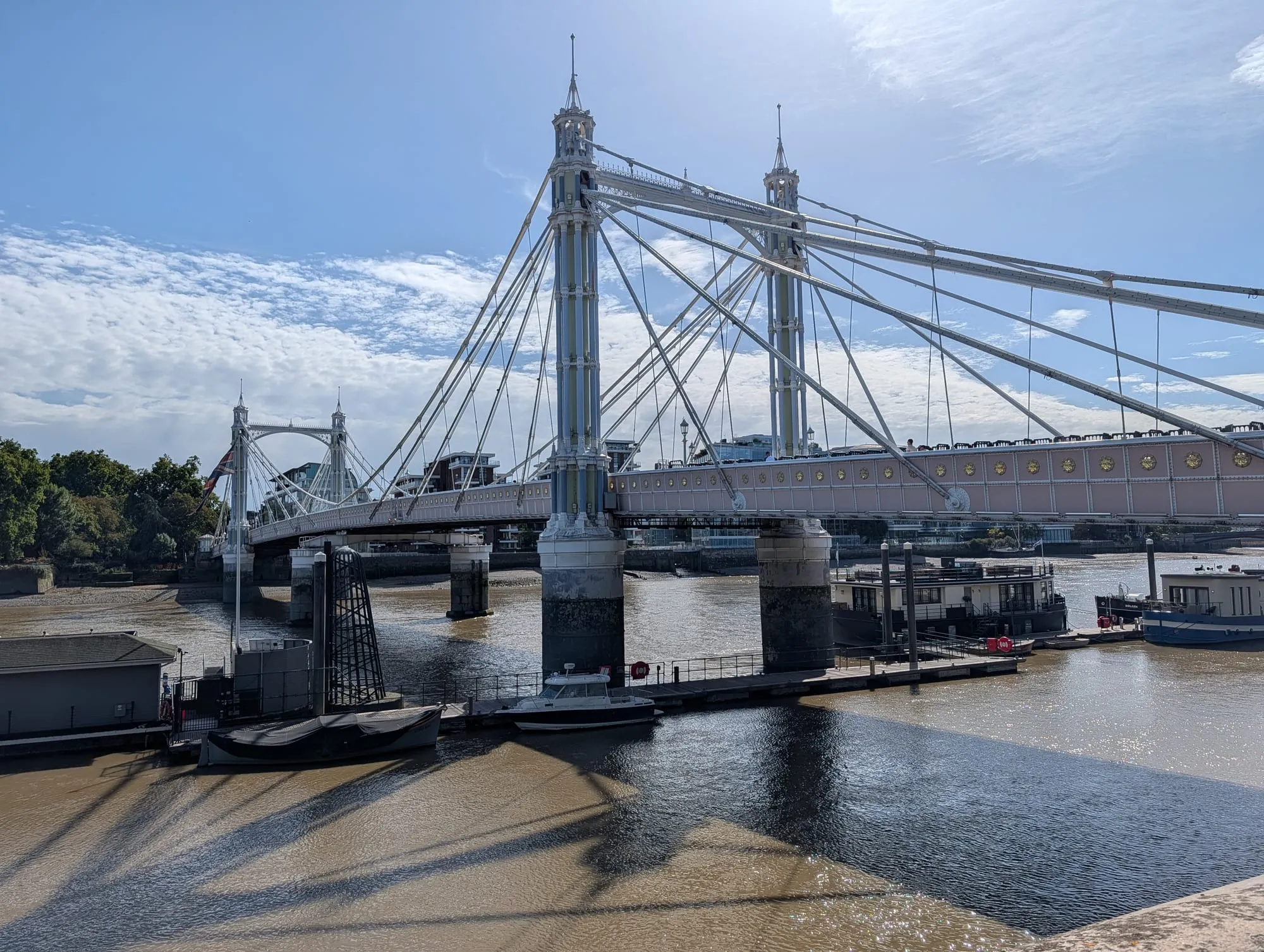 Albert Bridge over the Thames, its cast-iron towers and cables painted in pale pink, green and blue