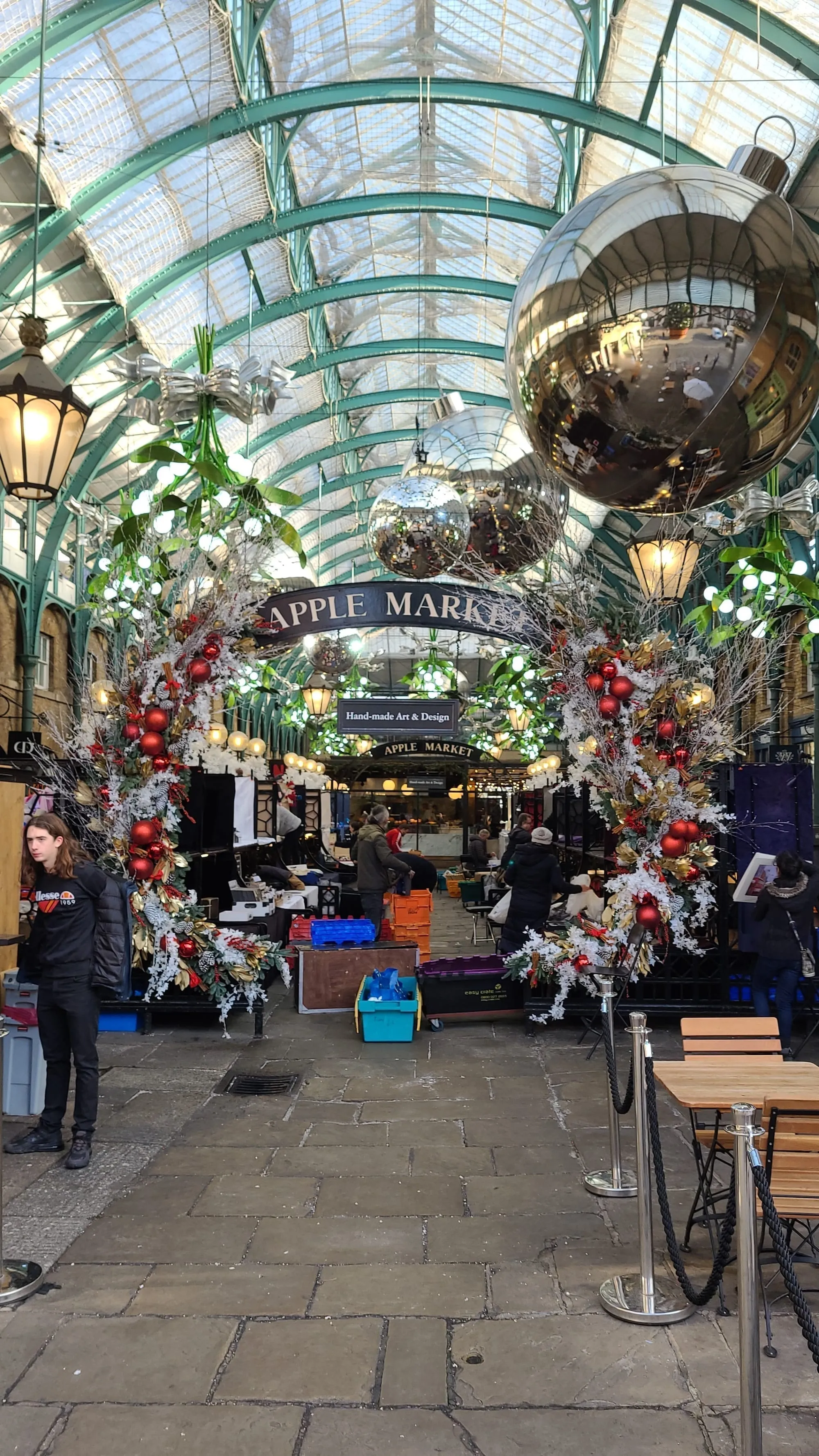 The Apple Market's cast-iron arcade decorated with giant baubles and mistletoe for Christmas