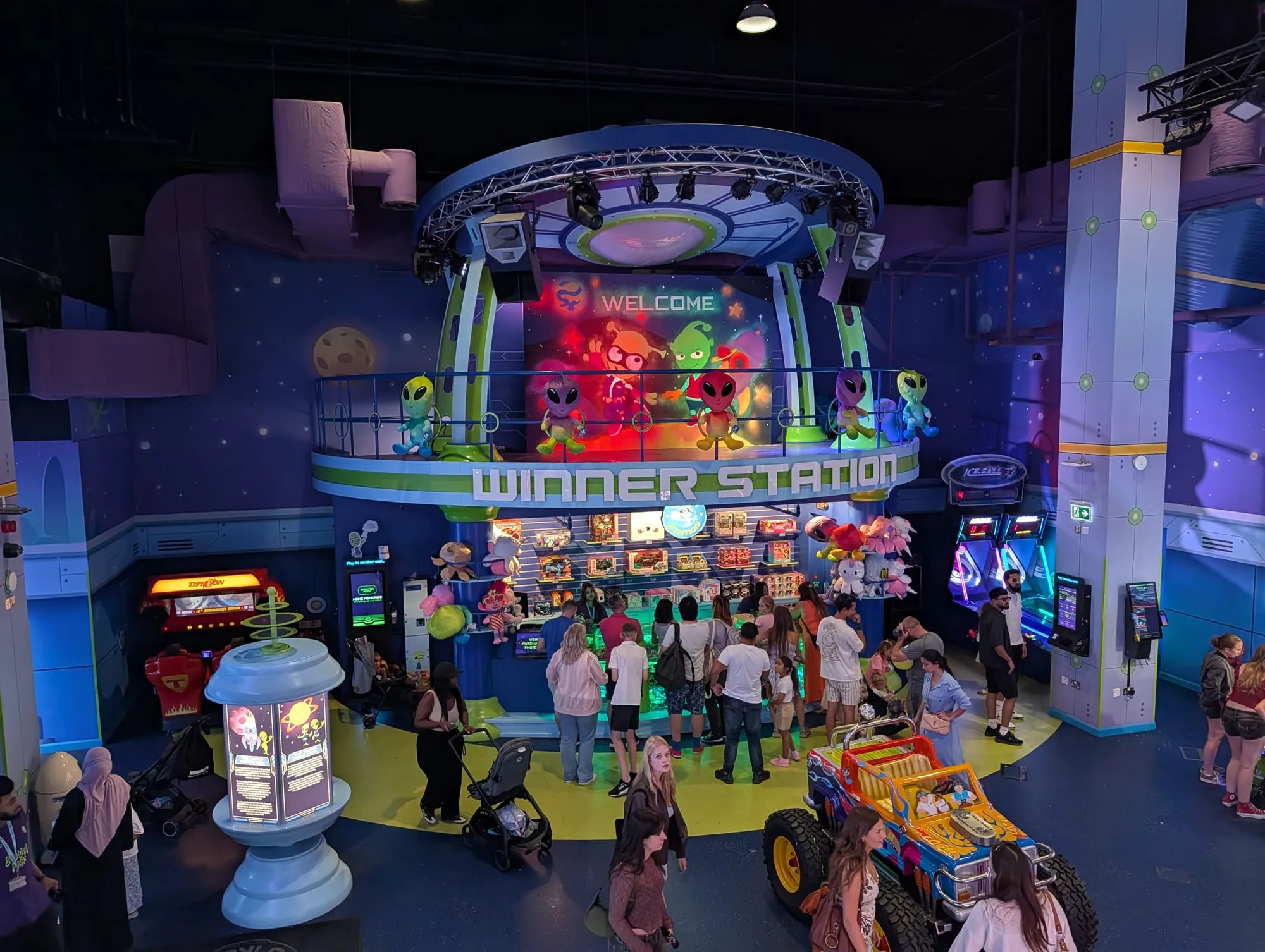 Neon-lit alien-themed rides and a flying saucer carousel inside Babylon Park in Camden