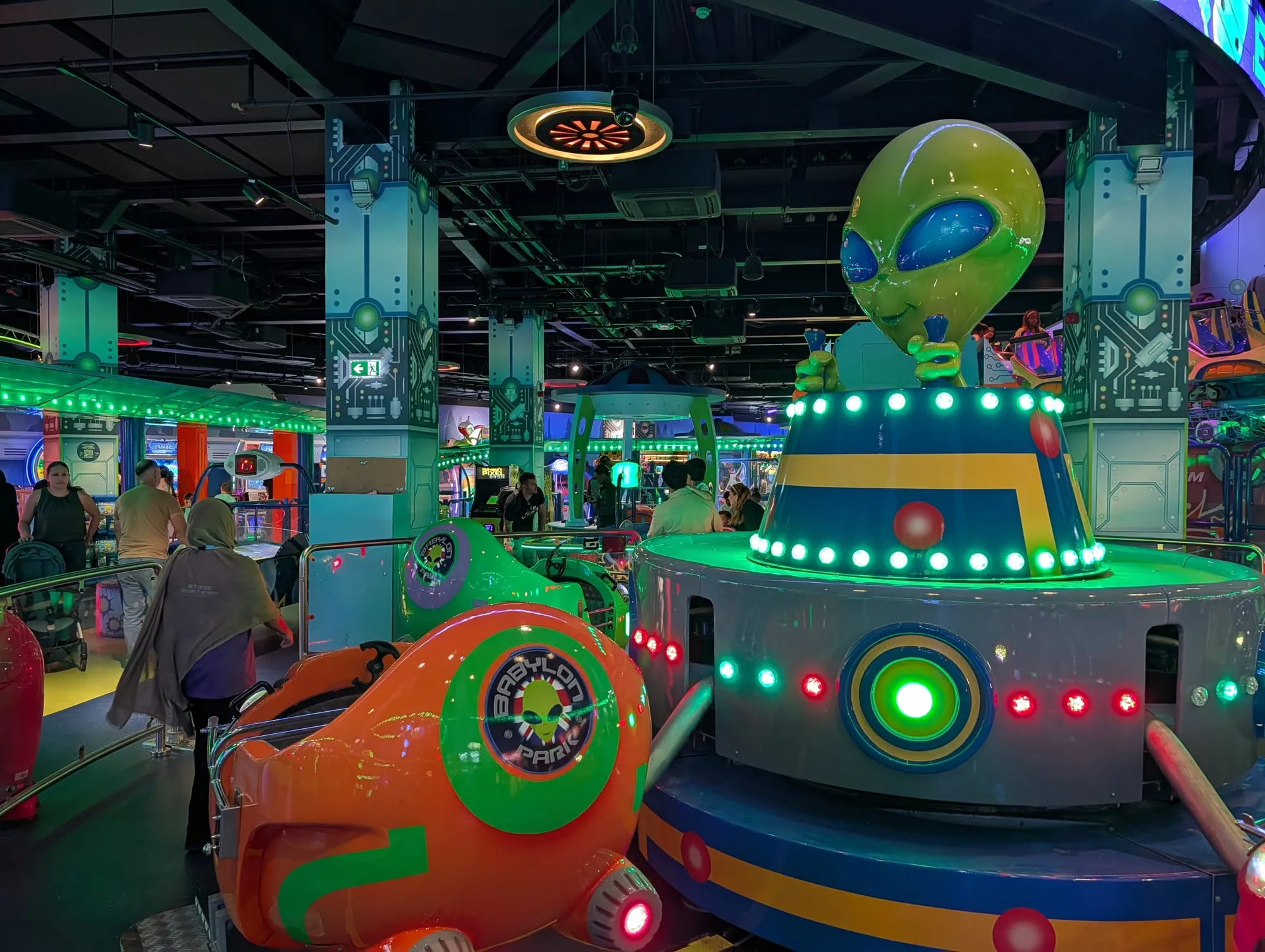 Neon-lit alien-themed rides and arcade machines inside Babylon Park in Camden