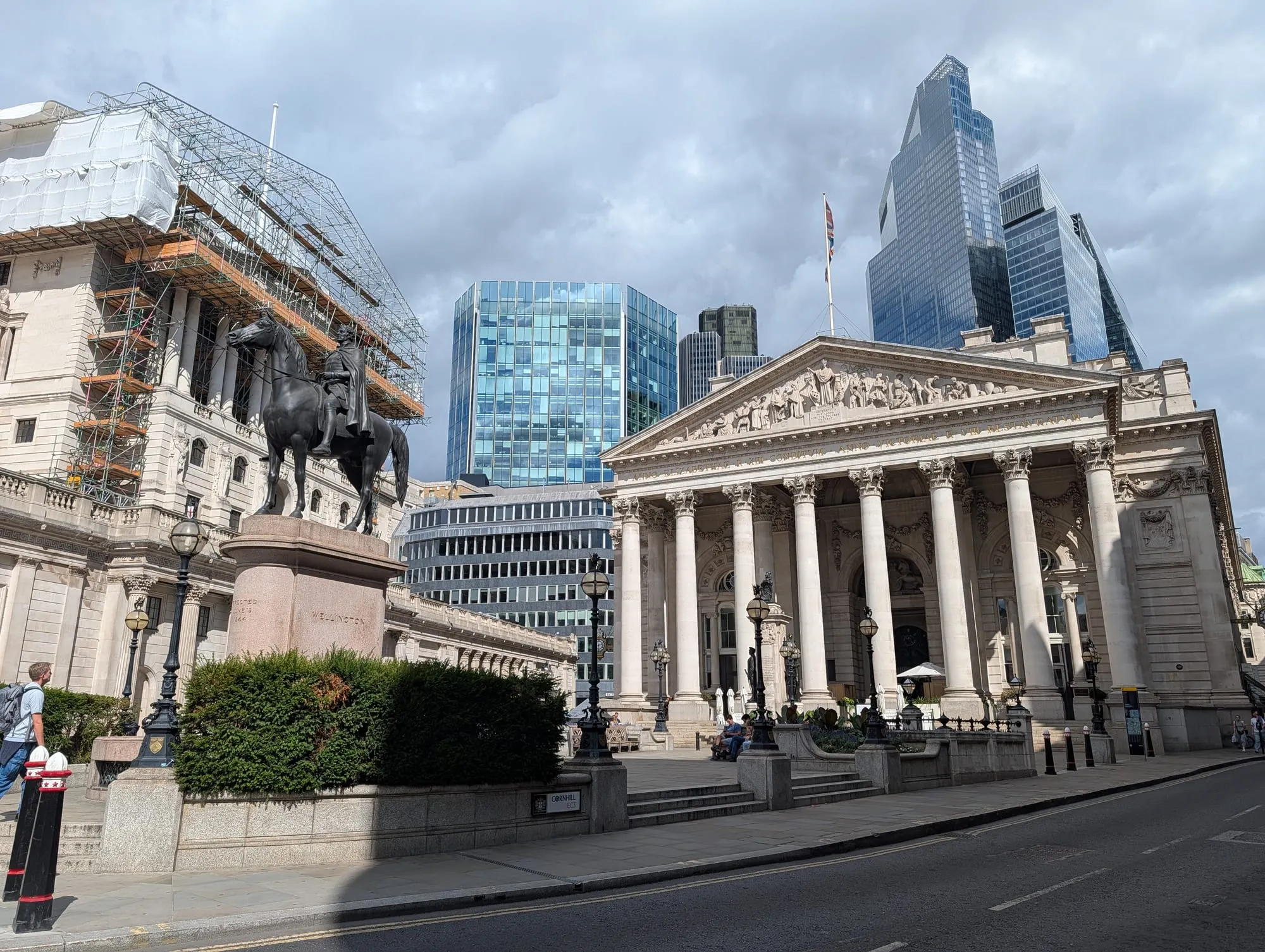 The Royal Exchange portico and the Bank of England at the Bank junction, with traffic and a red bus