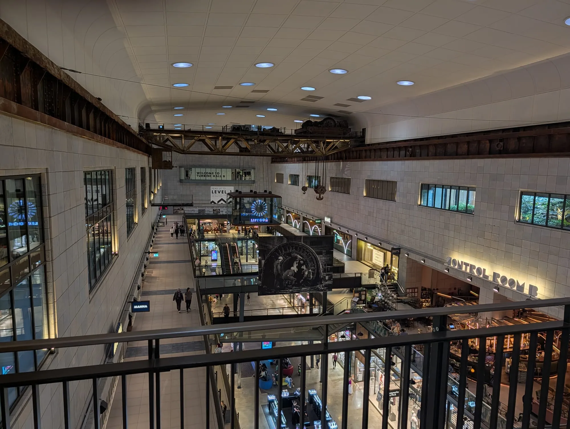 The restored interior of Battersea Power Station, with shops on multiple levels under the original steel roof