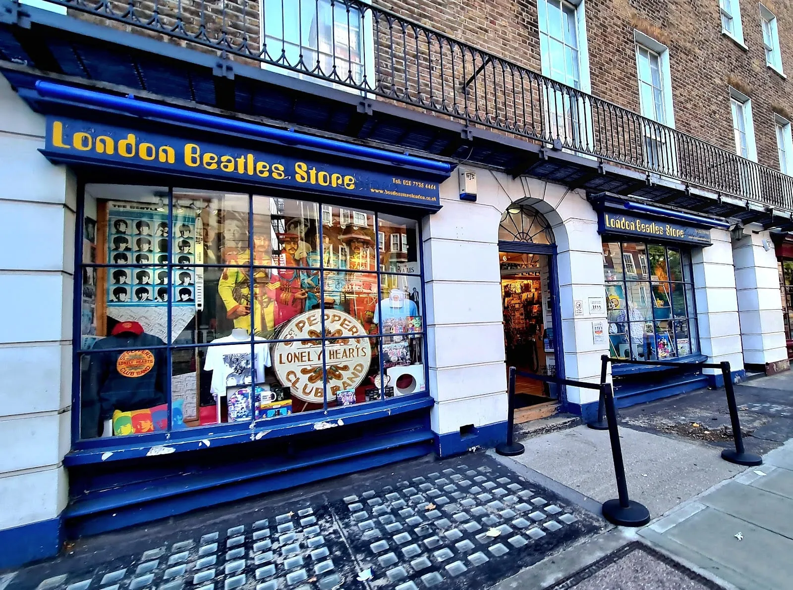 The London Beatles Store shopfront on Baker Street, its windows dressed with a Sgt. Pepper display and yellow lettering reading 'London Beatles Store' above