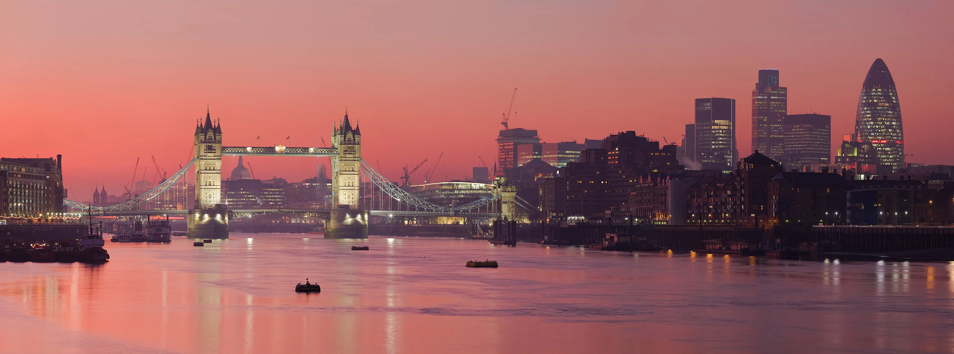 The London skyline and Tower Bridge at sunset across the River Thames