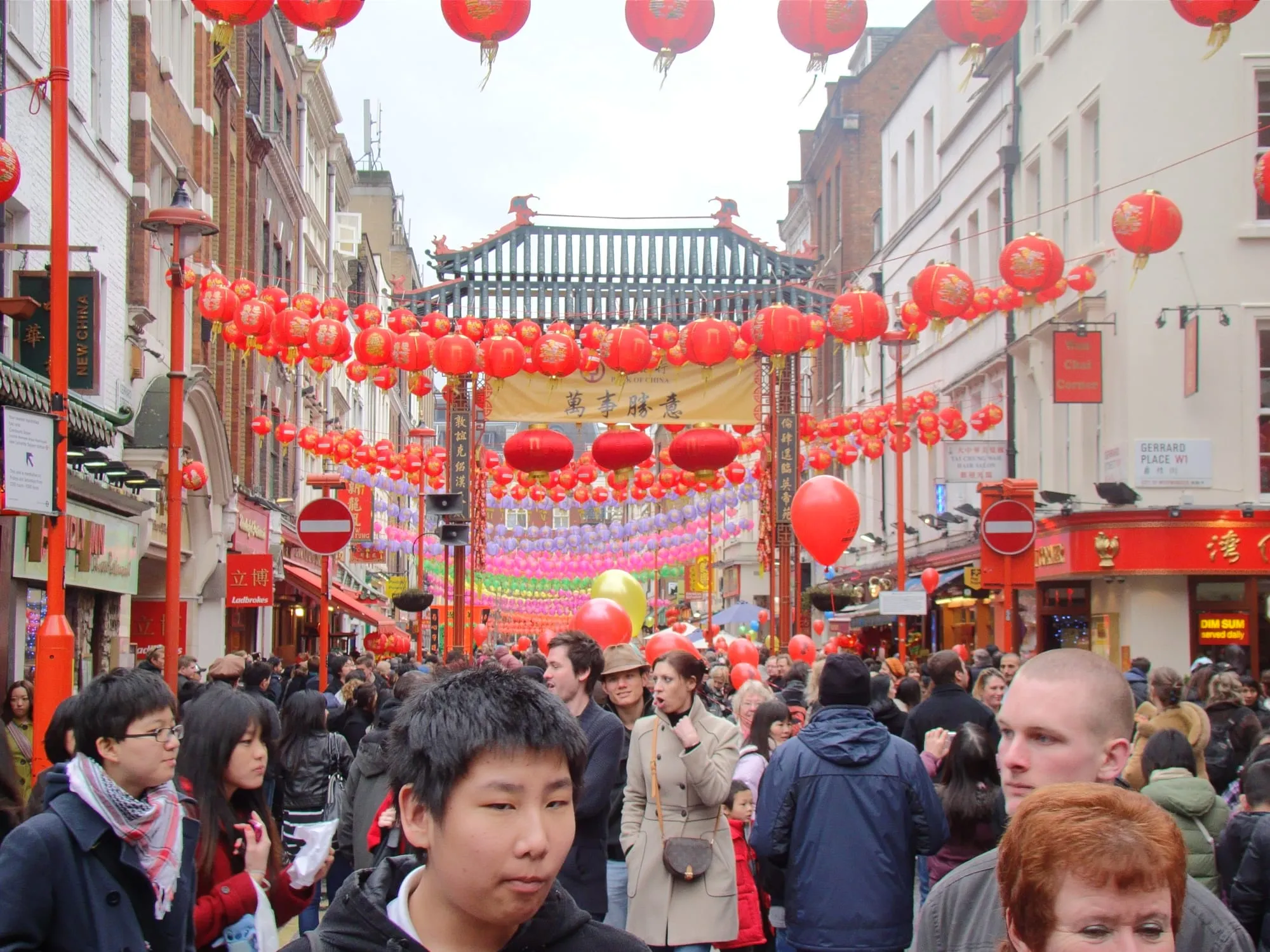 Red and gold lanterns strung in rows above Gerrard Street in London's Chinatown