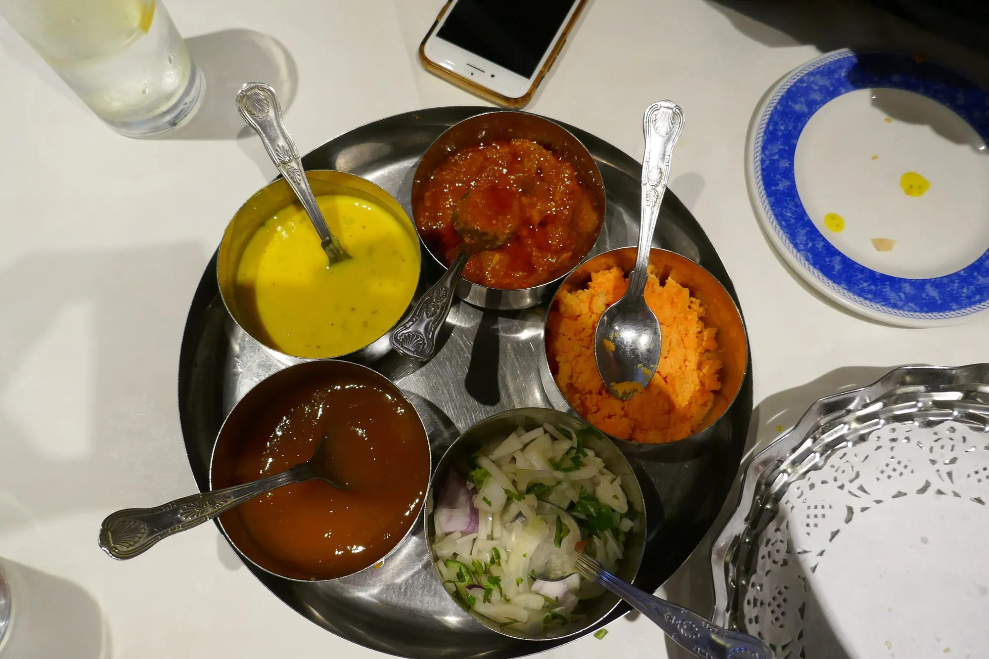 A table of Indian curries and accompaniments at a Brick Lane restaurant