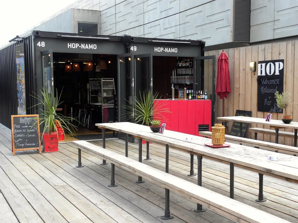 Shipping-container units and long wooden benches at Boxpark Shoreditch