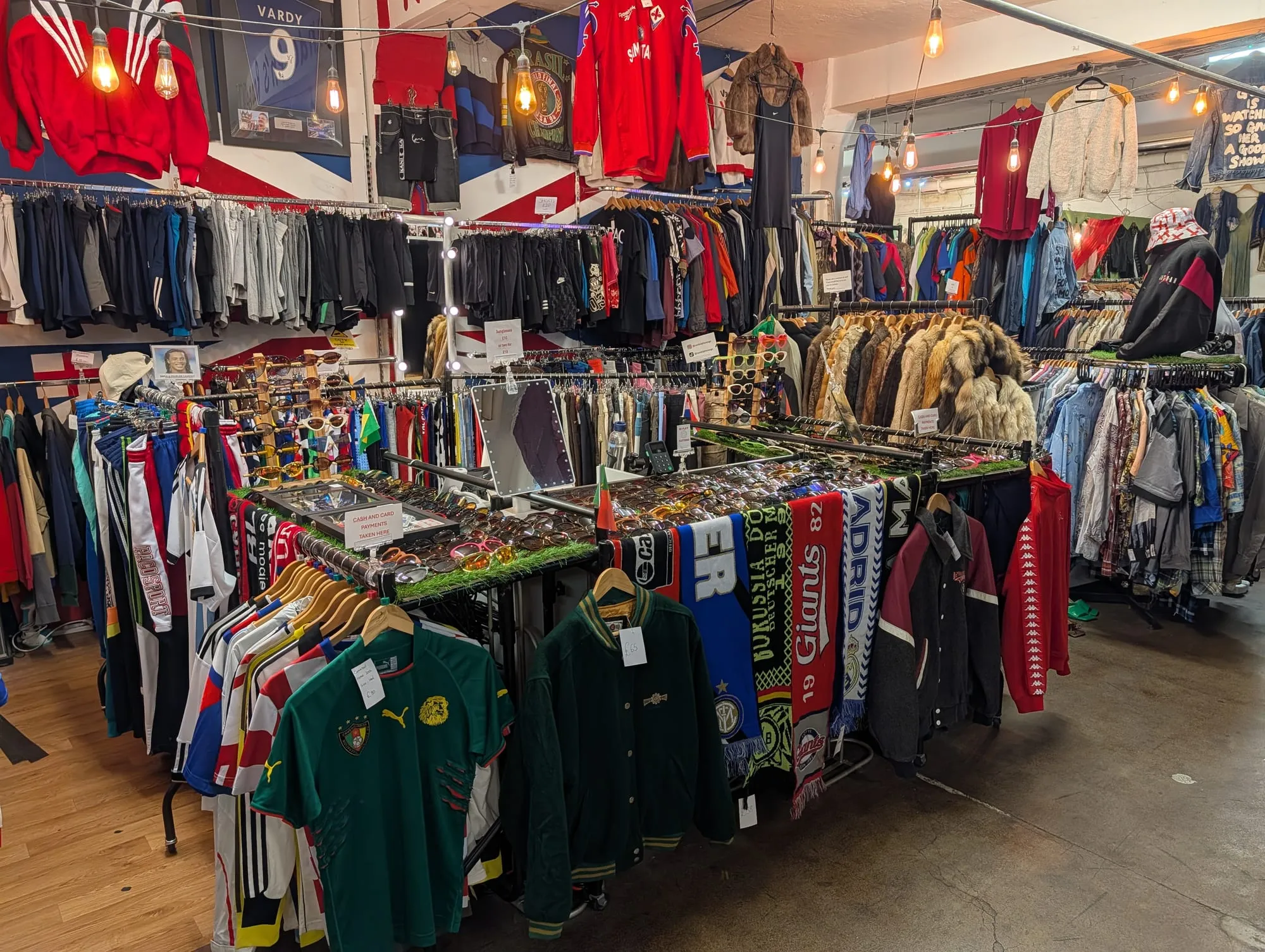 Rails of vintage clothing and racks of shirts inside the Brick Lane vintage market