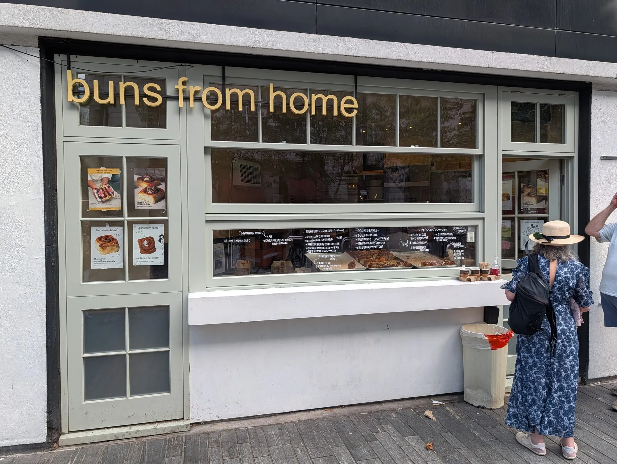 The Buns from Home shopfront, cream painted with the name in yellow lowercase lettering above a window counter
