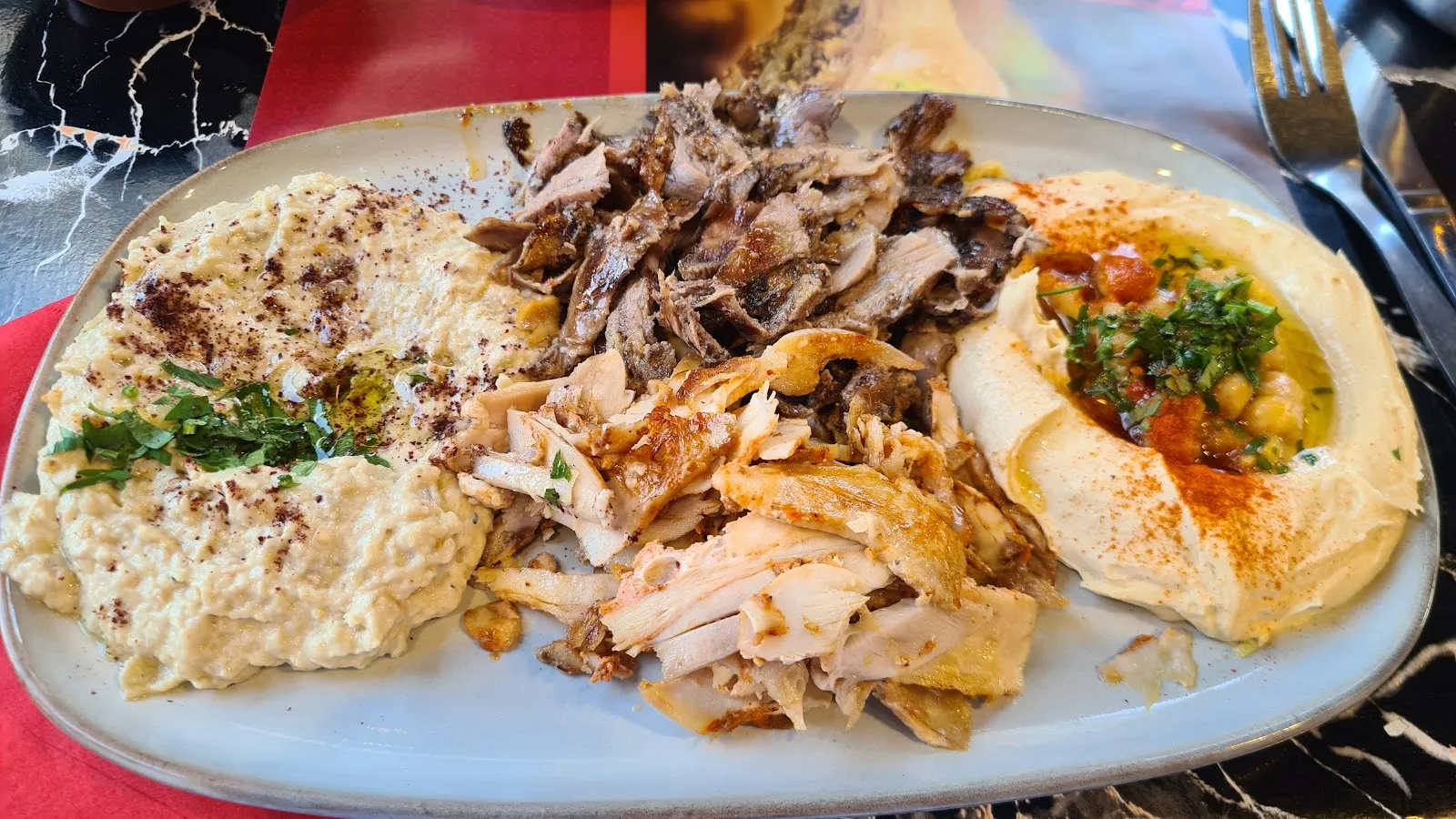 A mixed grill plate at Cafe Helen with hummus, moutabal and shredded lamb and chicken shawarma