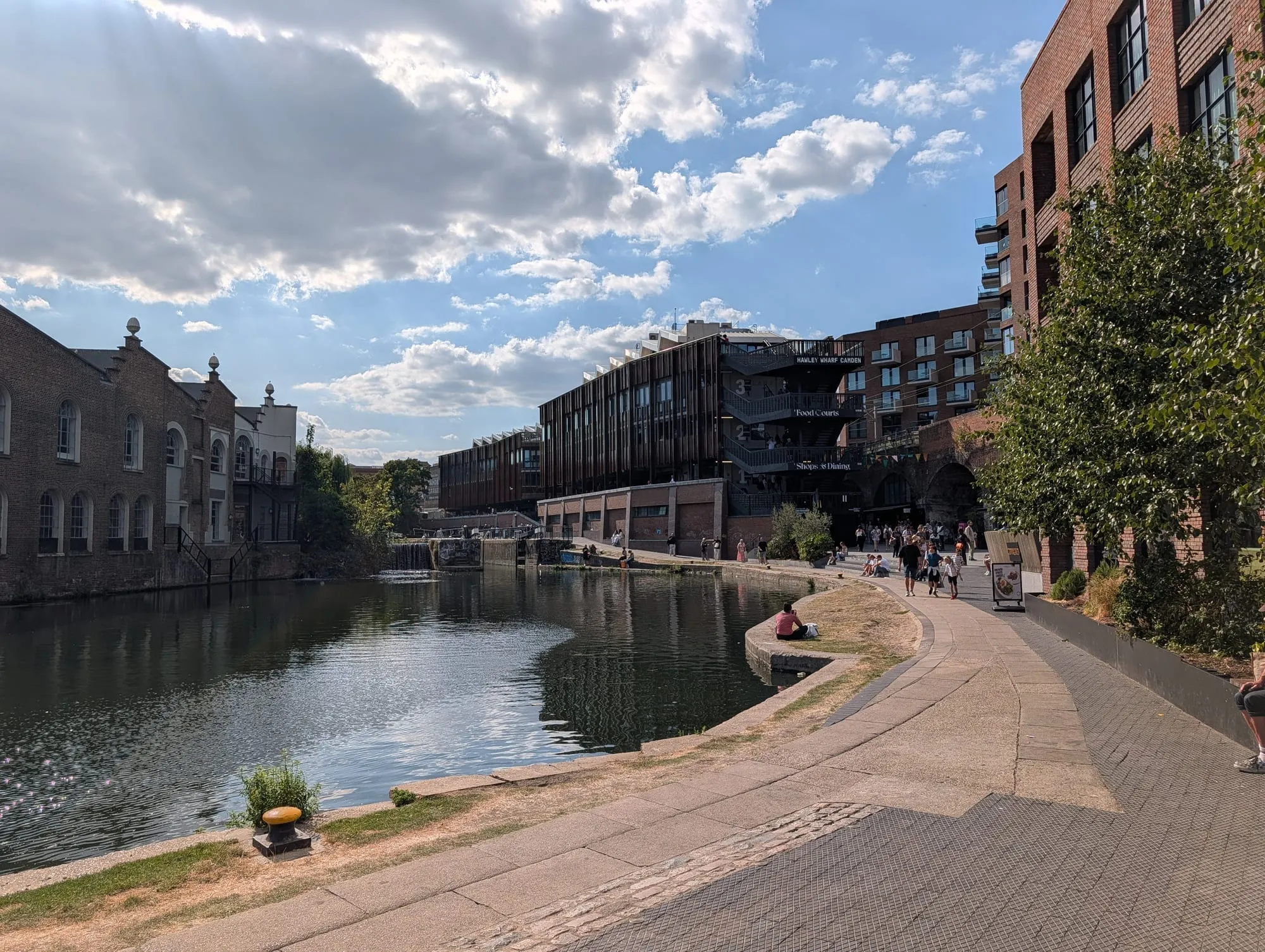 Redbrick warehouse buildings along the Regent's Canal at Hawley Wharf, with the towpath running below