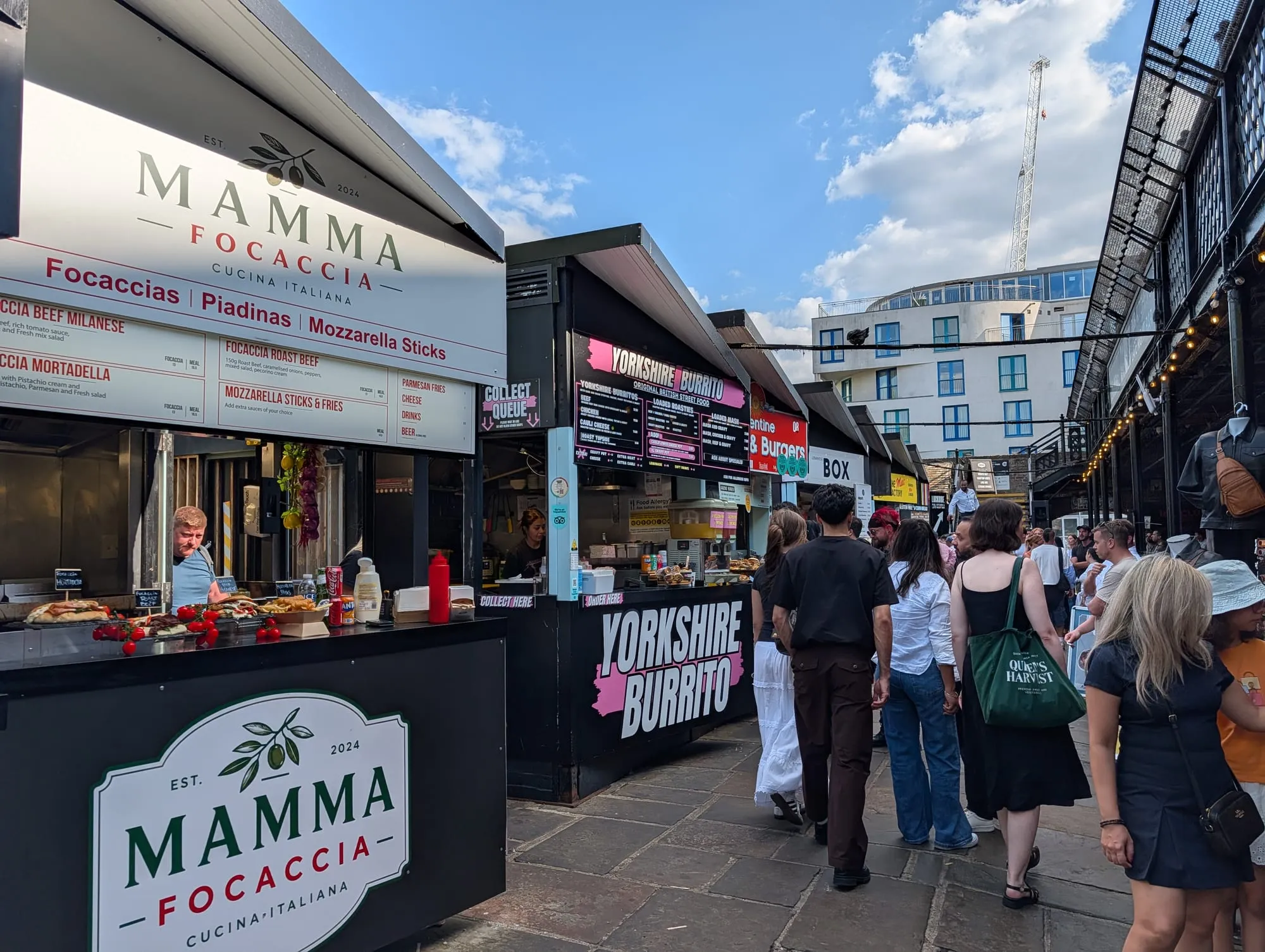 Street food counters in Camden Market, including a focaccia stall and a burrito stall