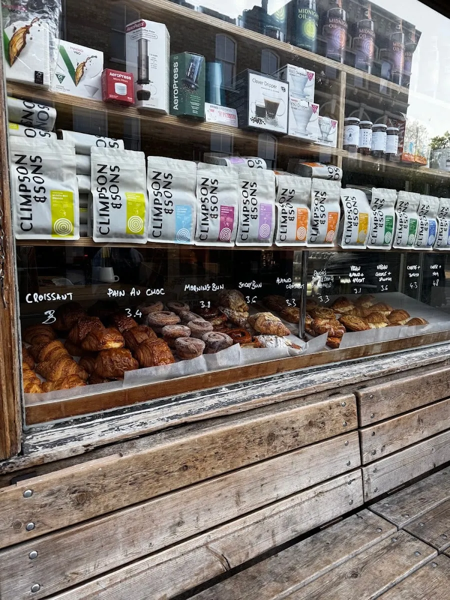 The window display at Climpson & Sons, with rows of bagged coffee beans and a tray of pastries below