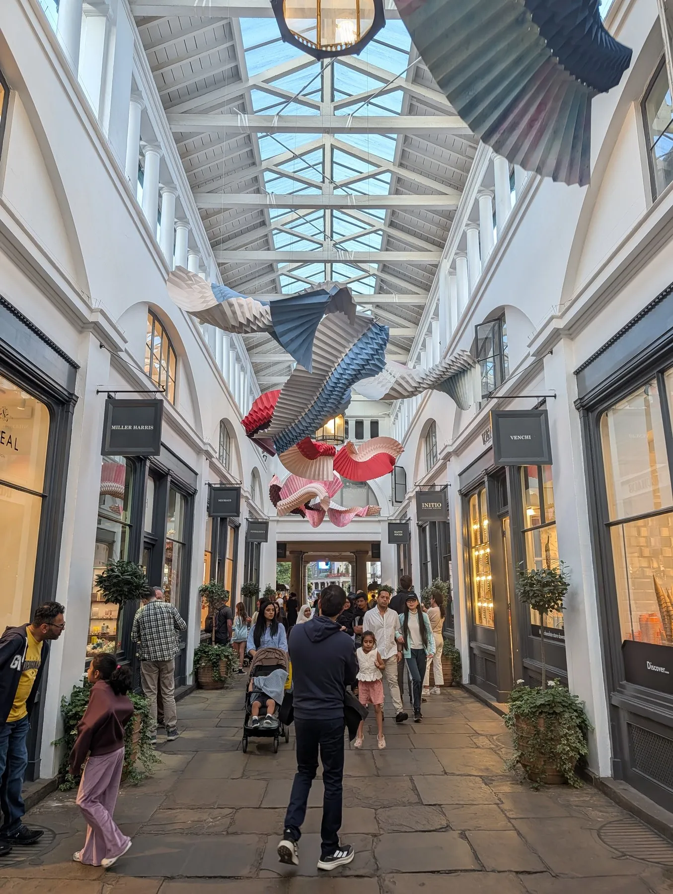 The glass-roofed arcade inside Covent Garden's market building, lined with small shops