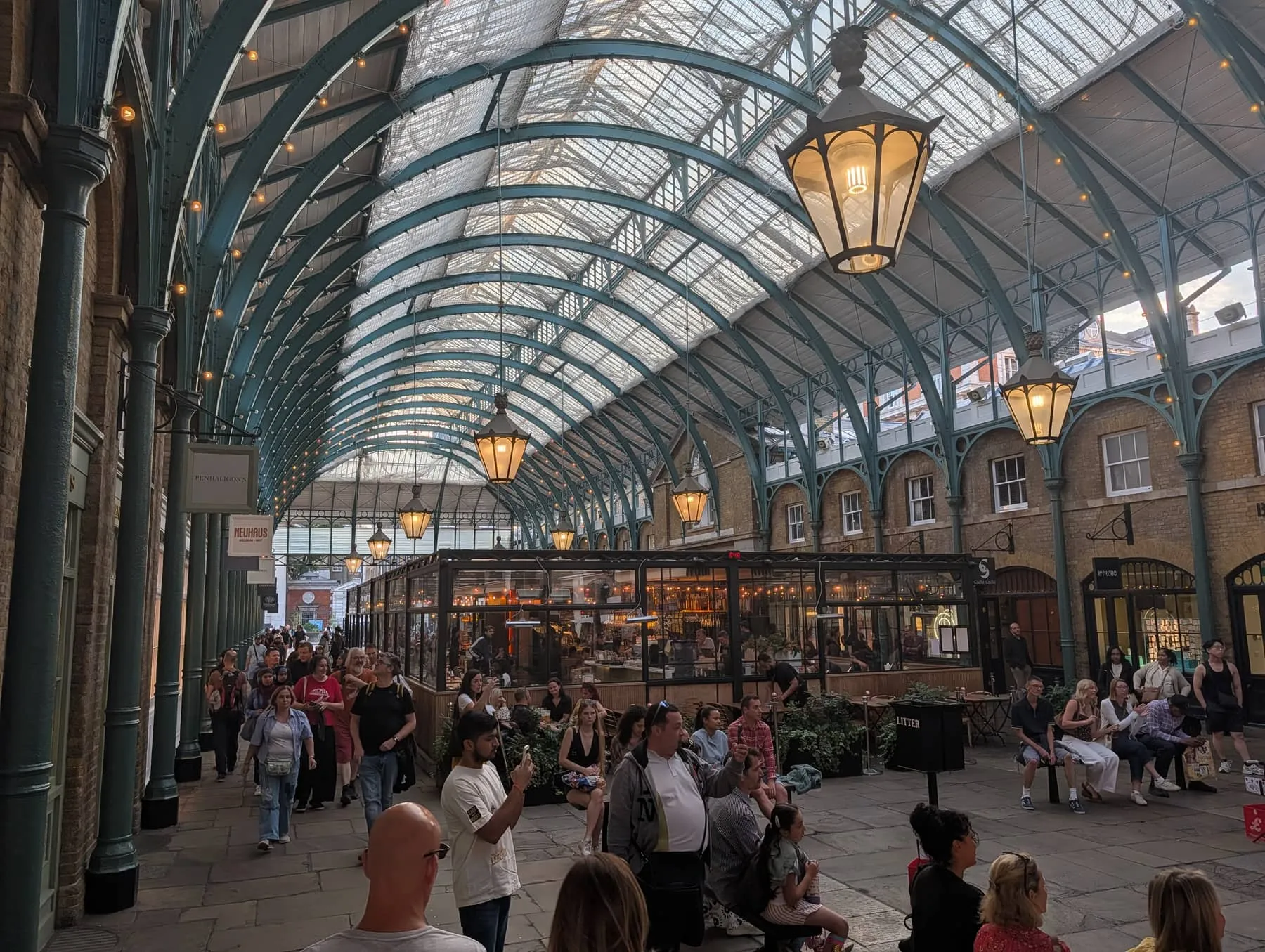 The glass-roofed Apple Market hall at Covent Garden, with stalls beneath the iron and glass arcade