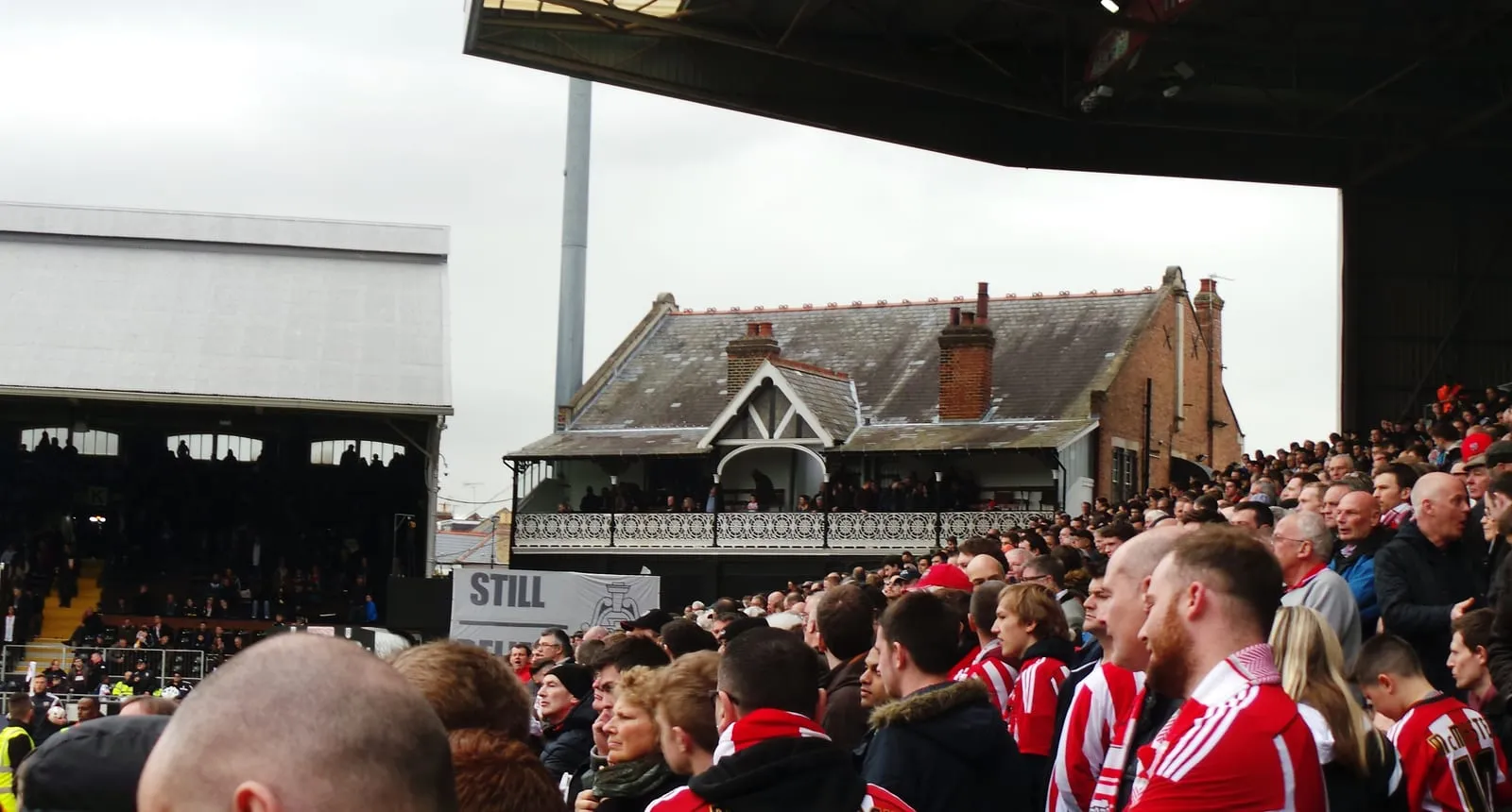 The historic red-brick Cottage pavilion and stands at Craven Cottage on the banks of the Thames