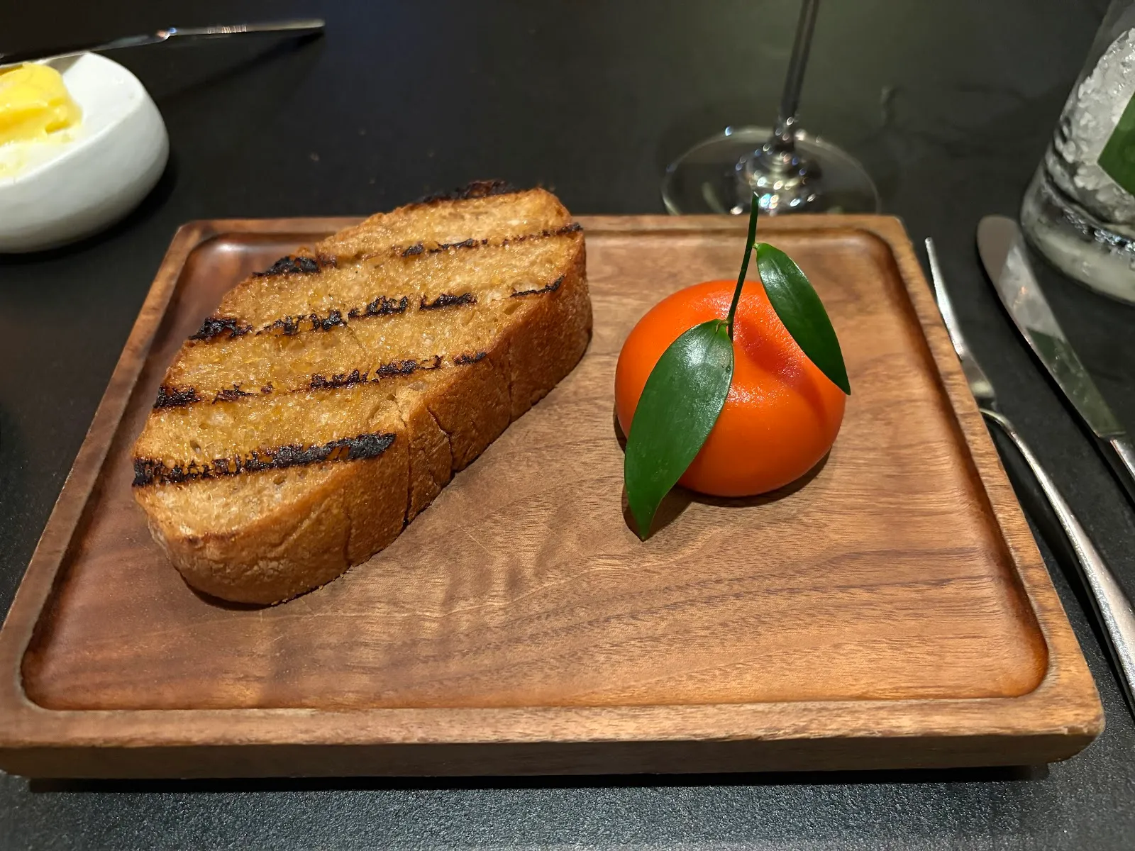 The Meat Fruit at Dinner by Heston Blumenthal, a chicken liver parfait moulded and glazed to look like a mandarin, served on a board with grilled sourdough