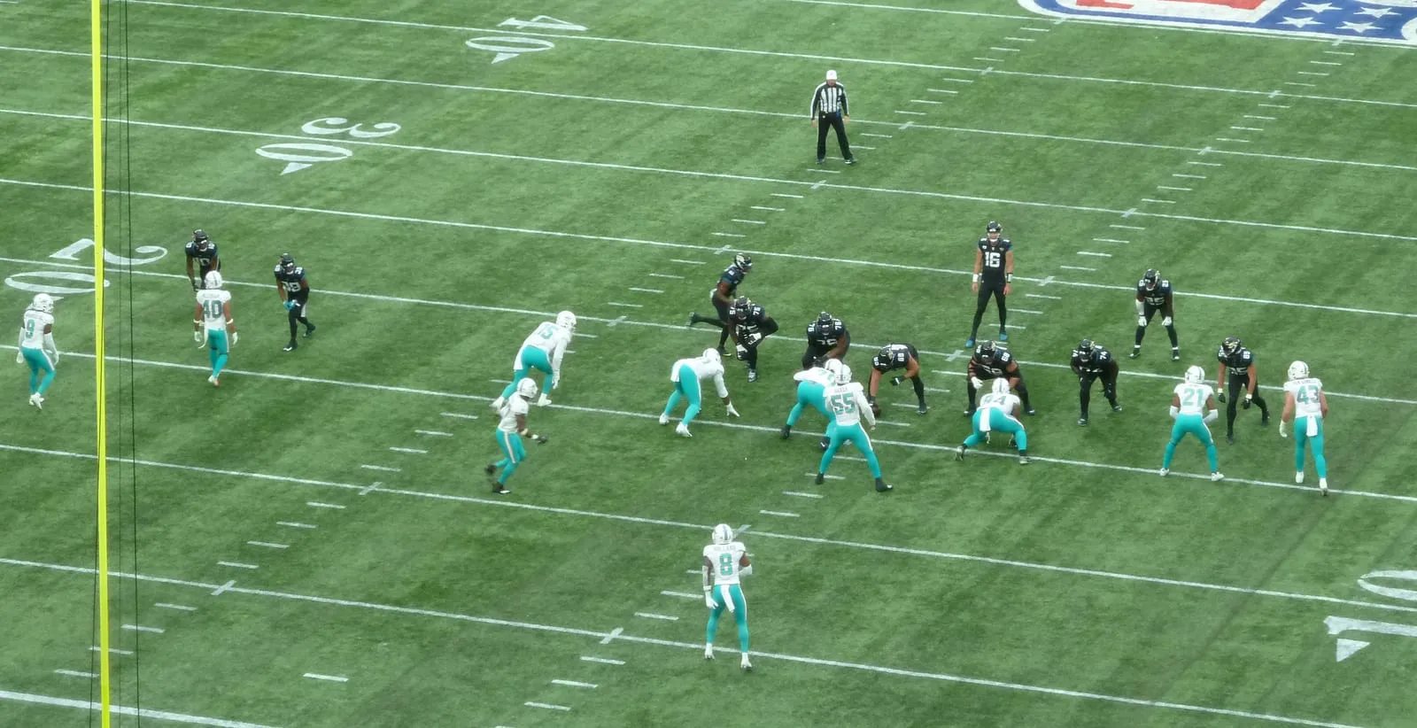 Miami Dolphins and Jacksonville Jaguars players in action on the synthetic turf at Tottenham Hotspur Stadium