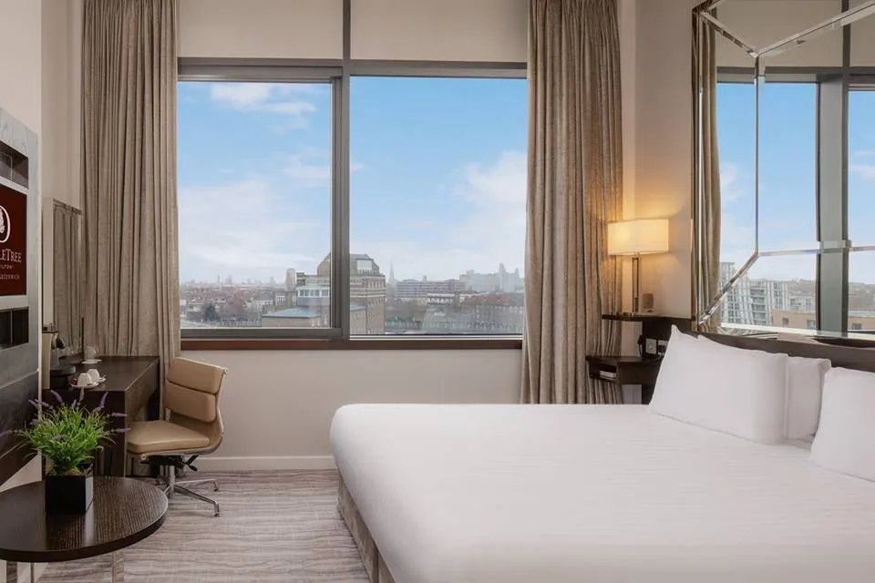 A room at DoubleTree by Hilton London Greenwich with floor-to-ceiling windows over the rooftops