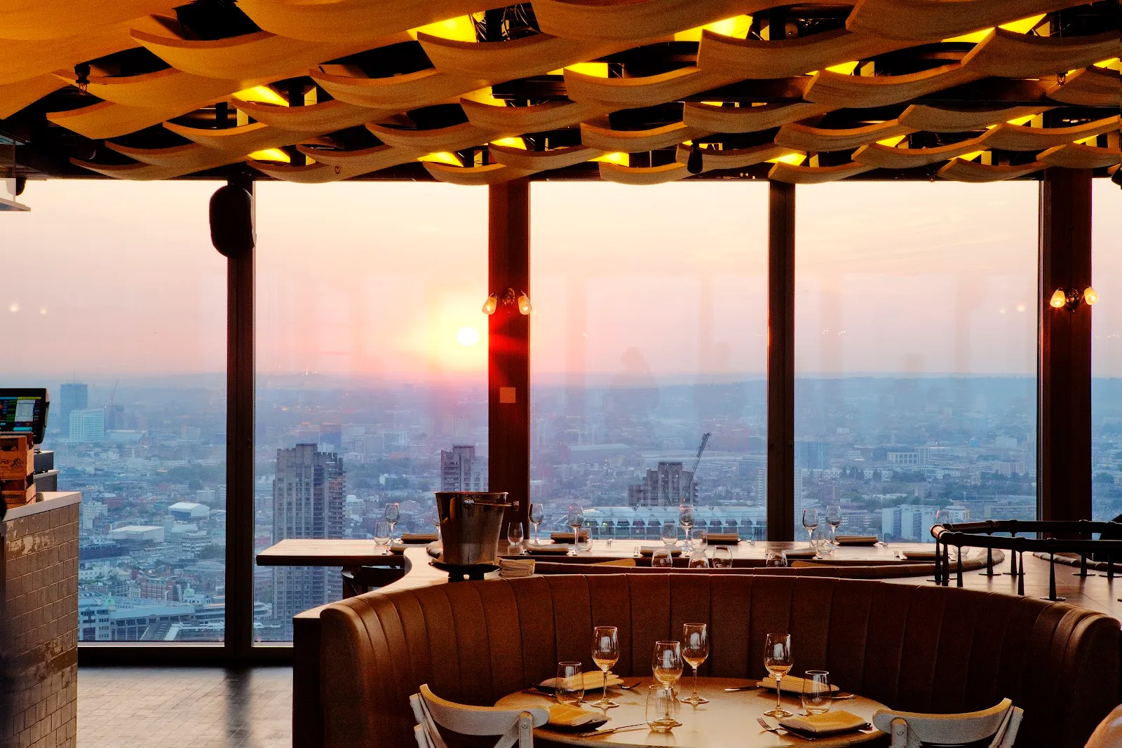 The dining room at Duck & Waffle, forty floors up in the Heron Tower, with floor-to-ceiling windows over the City at dusk