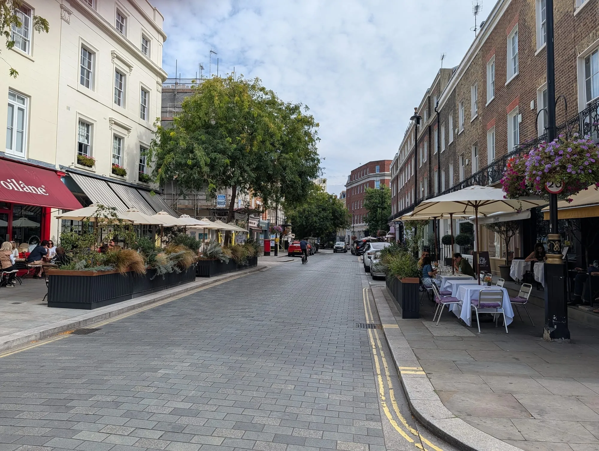 Elizabeth Street in Belgravia, a quiet street of independent shops with awnings, planters and outdoor tables