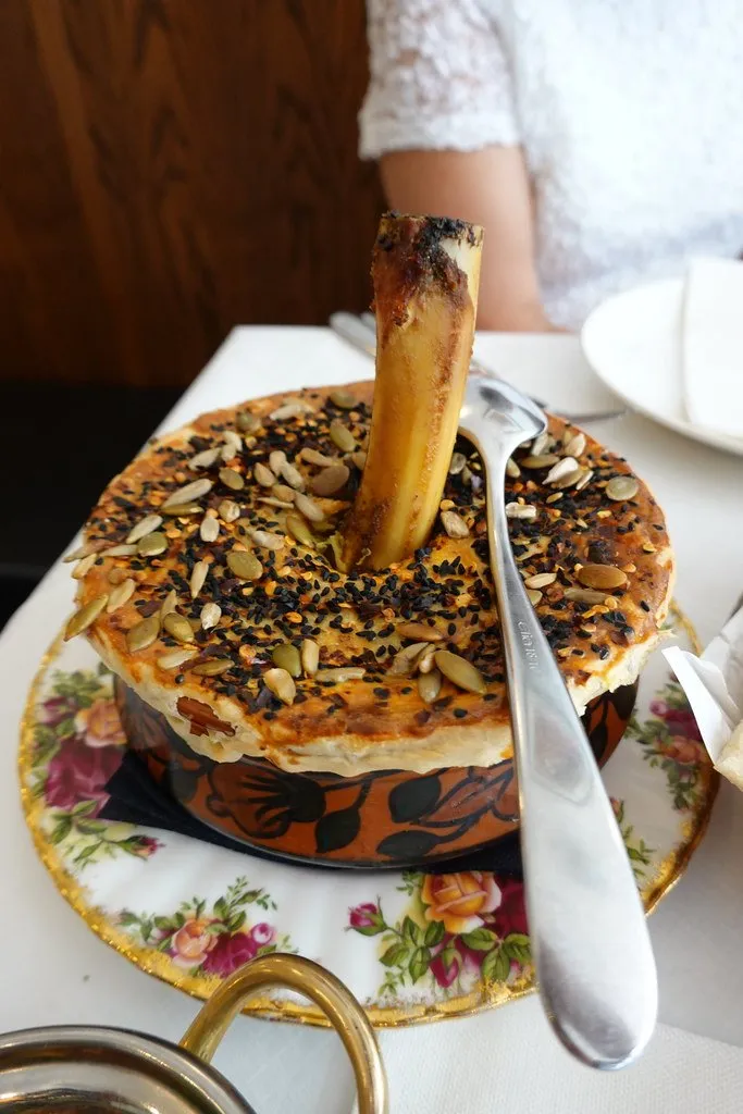 A bowl of aloo dish served on floral vintage china