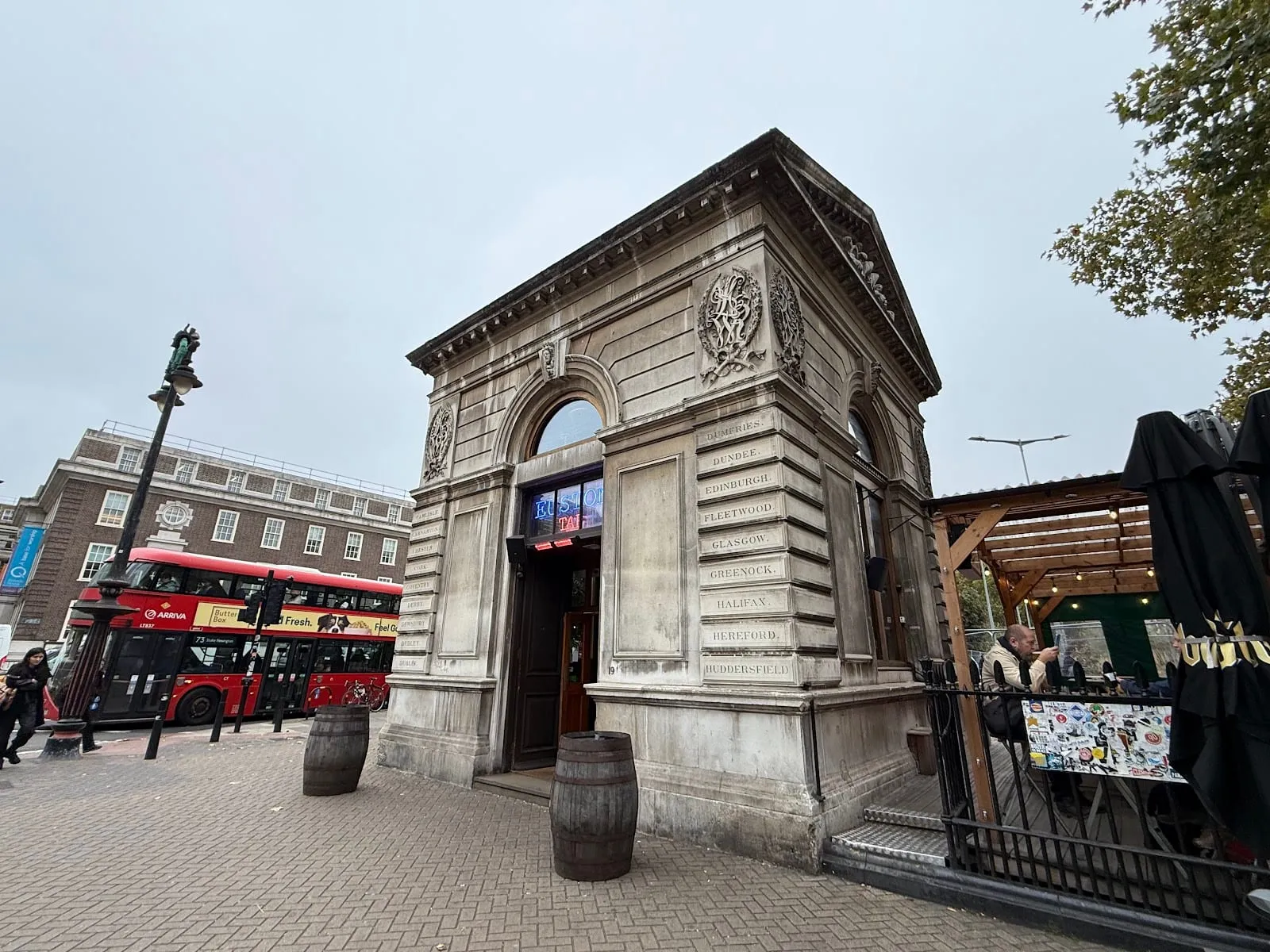 Euston Tap's stone gatehouse lodge on Euston Road, its walls still carved with mainline destinations from the old station entrance