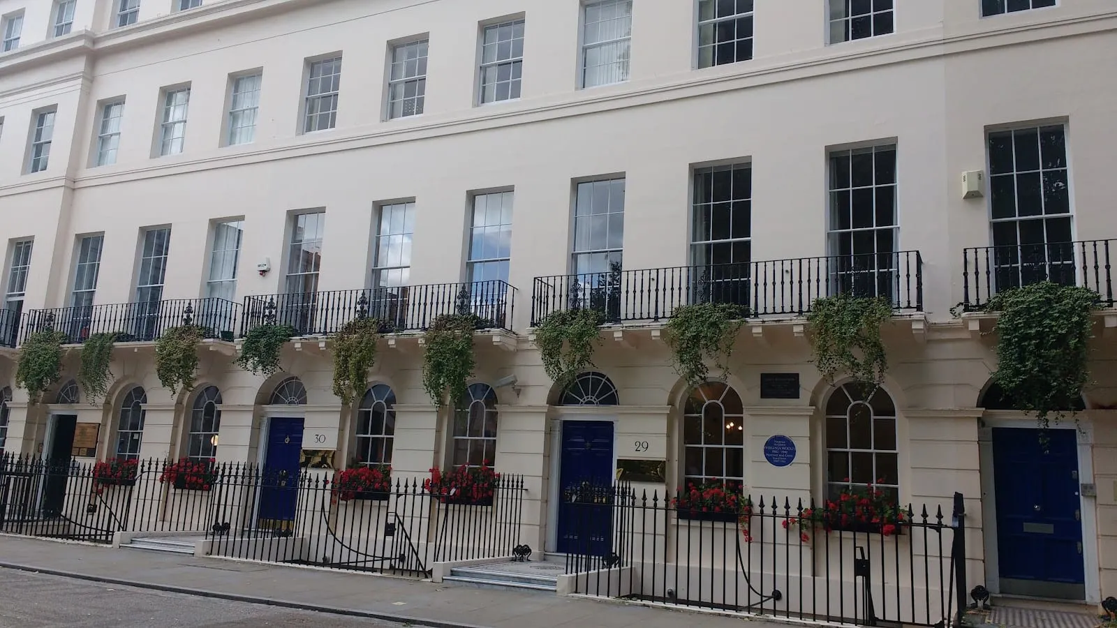The cream Georgian terrace at Fitzroy Square with a blue plaque and door at number 29
