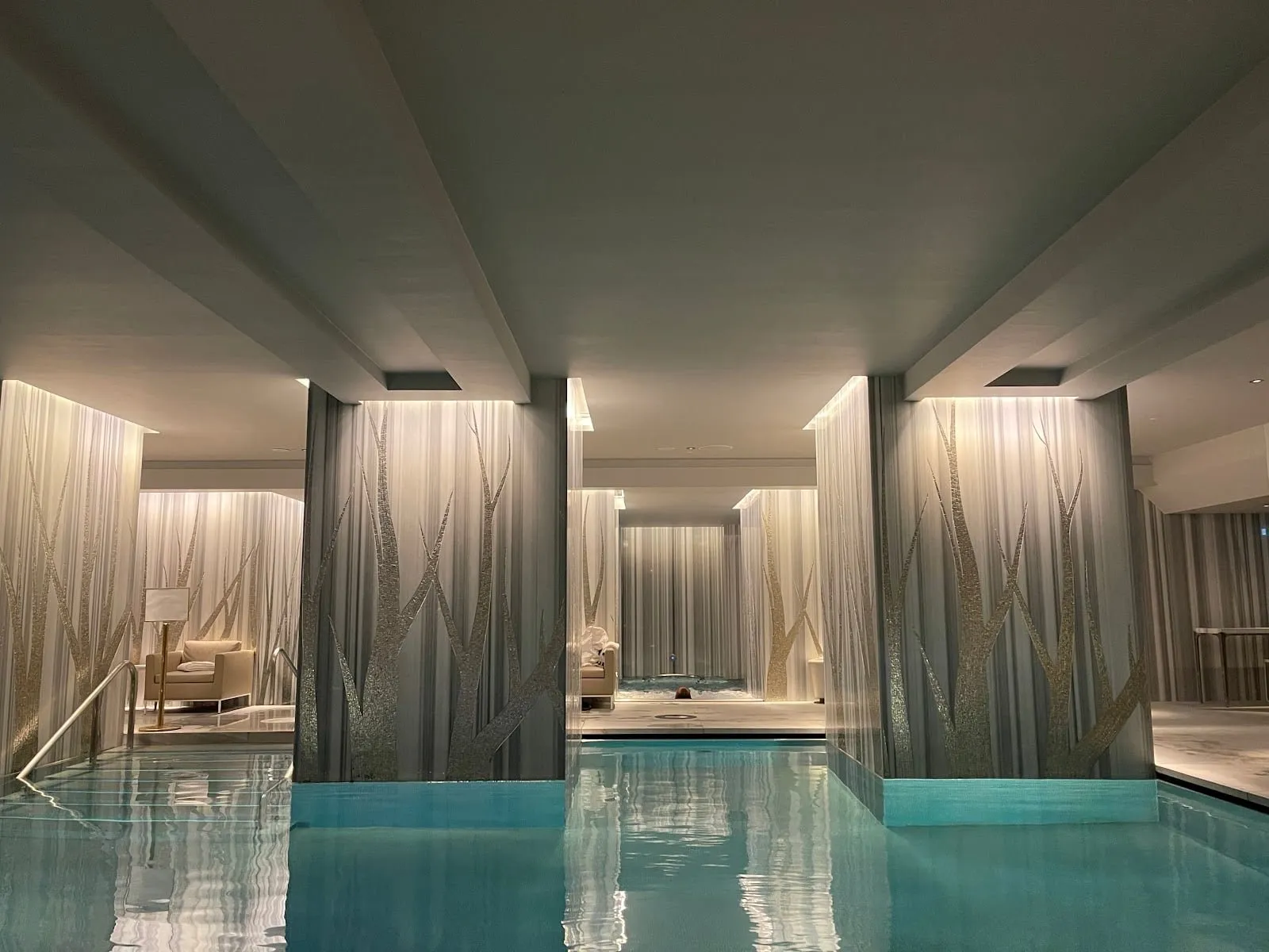 The spa pool at Four Seasons Hotel London at Tower Bridge, between pillars decorated with tree designs