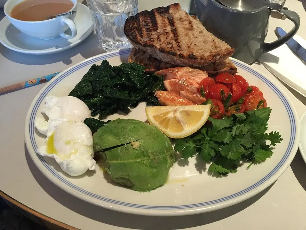 A Granger & Co plate of poached eggs, smoked salmon, avocado, spinach and grilled sourdough