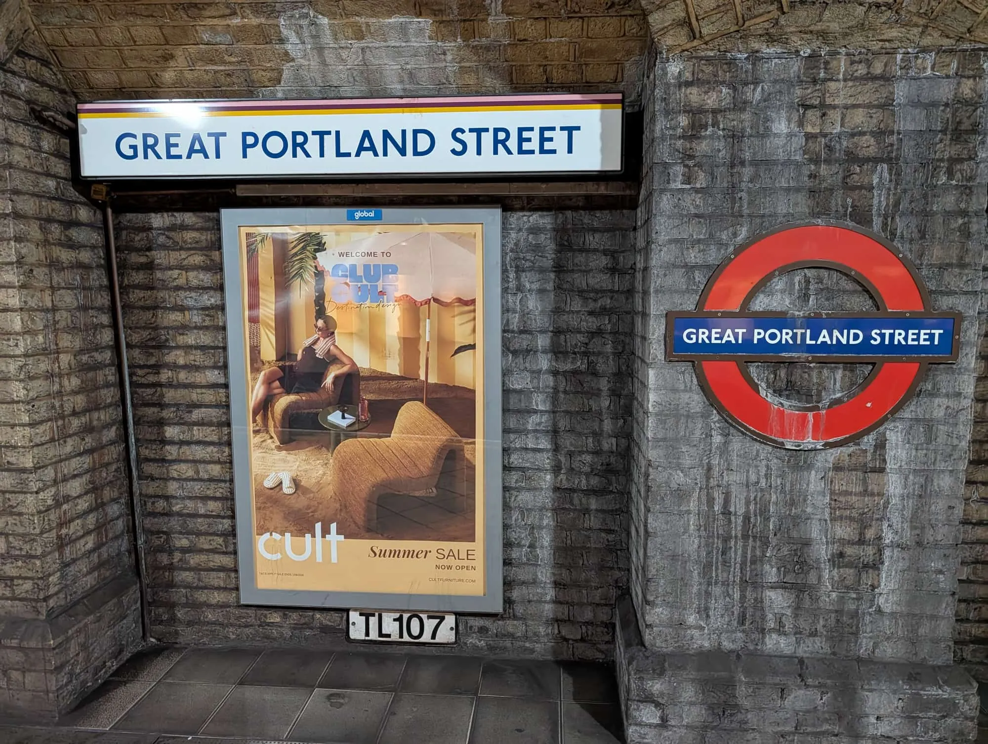 The Underground roundel and station name sign on the platform wall at Great Portland Street