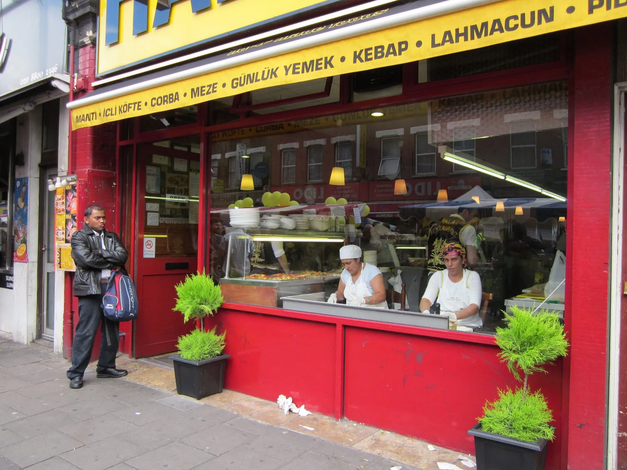 Women making gozleme in the window of Hala Restaurant on Green Lanes, Harringay, during the Green Lanes Festival
