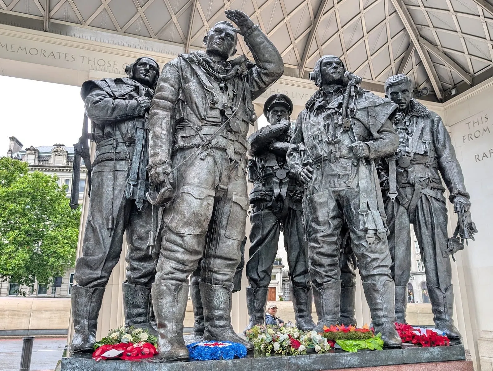 The bronze figures of RAF aircrew at the Bomber Command Memorial in Green Park, sheltered under its open roof
