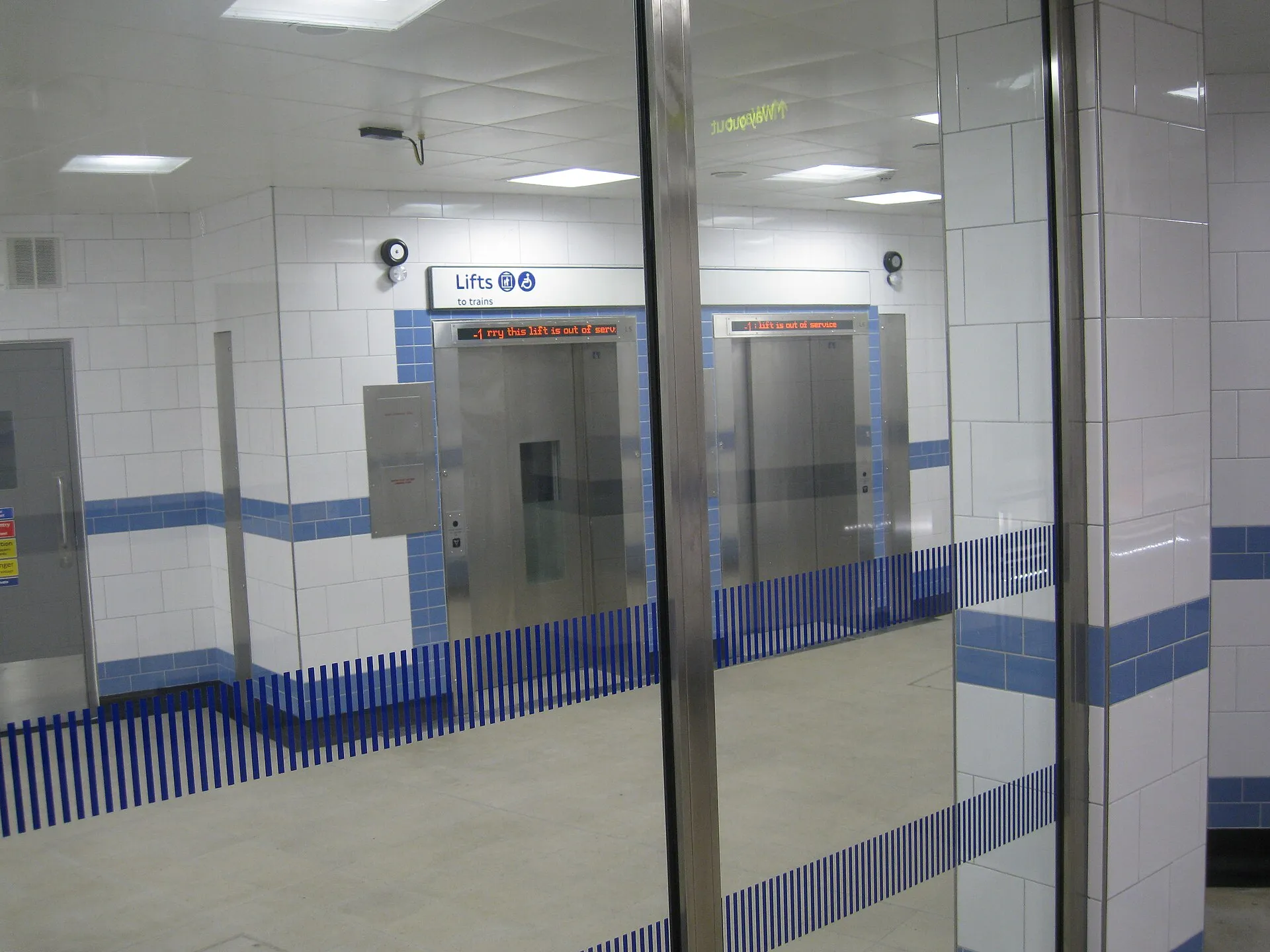Lifts down to the platforms at Green Park station, with step-free access signage beside the lift doors