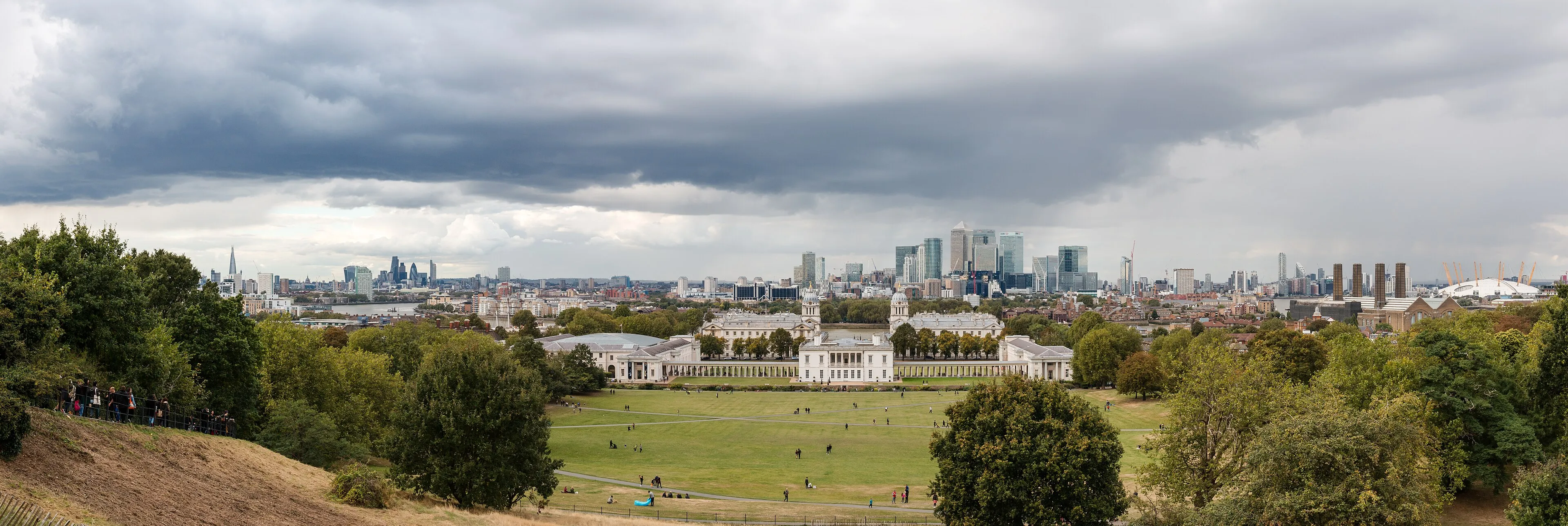 A panoramic view across Greenwich Park towards Canary Wharf and central London