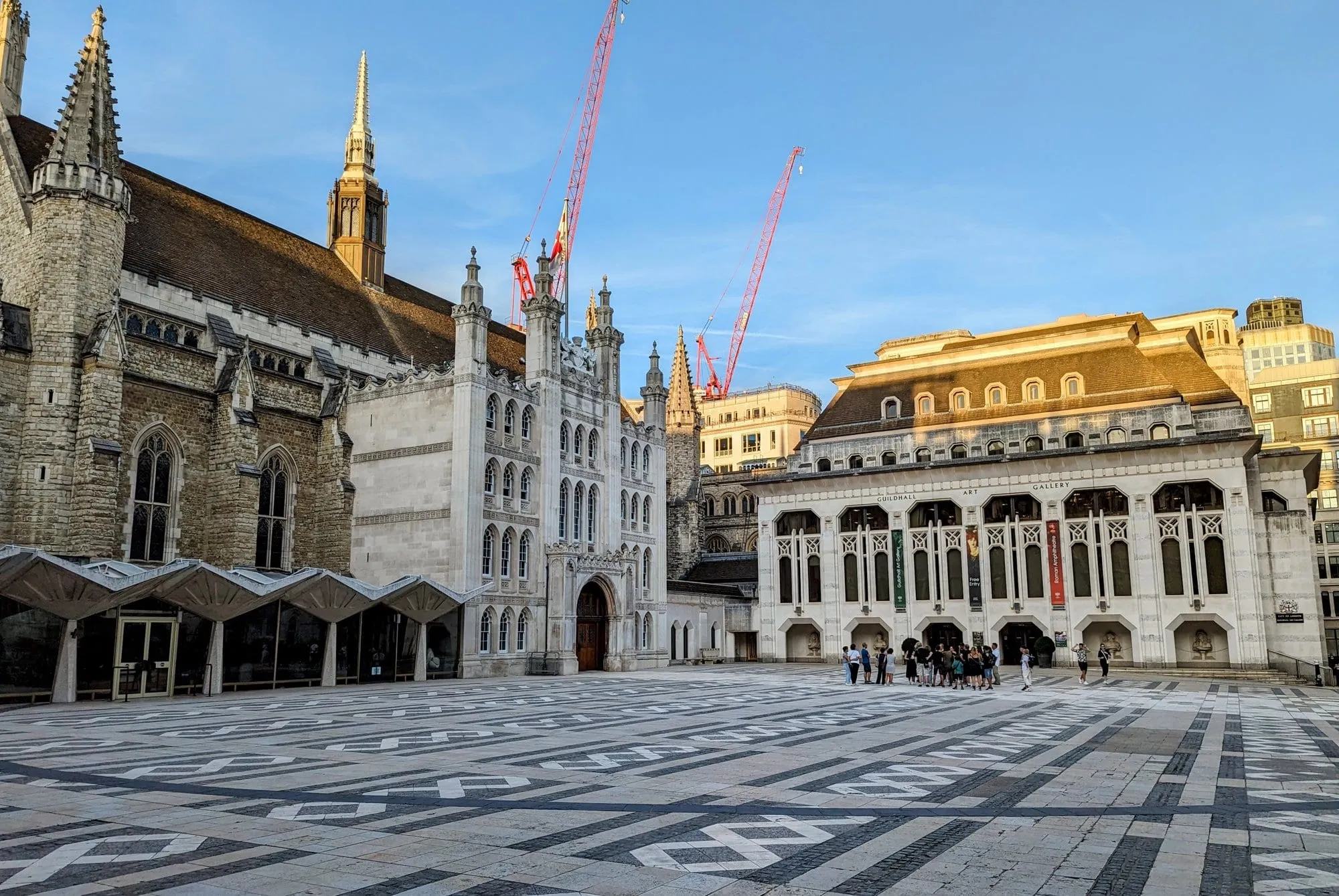 Guildhall Yard at sunset, with the medieval Guildhall on one side and the Guildhall Art Gallery, entrance to the Roman amphitheatre, on the other