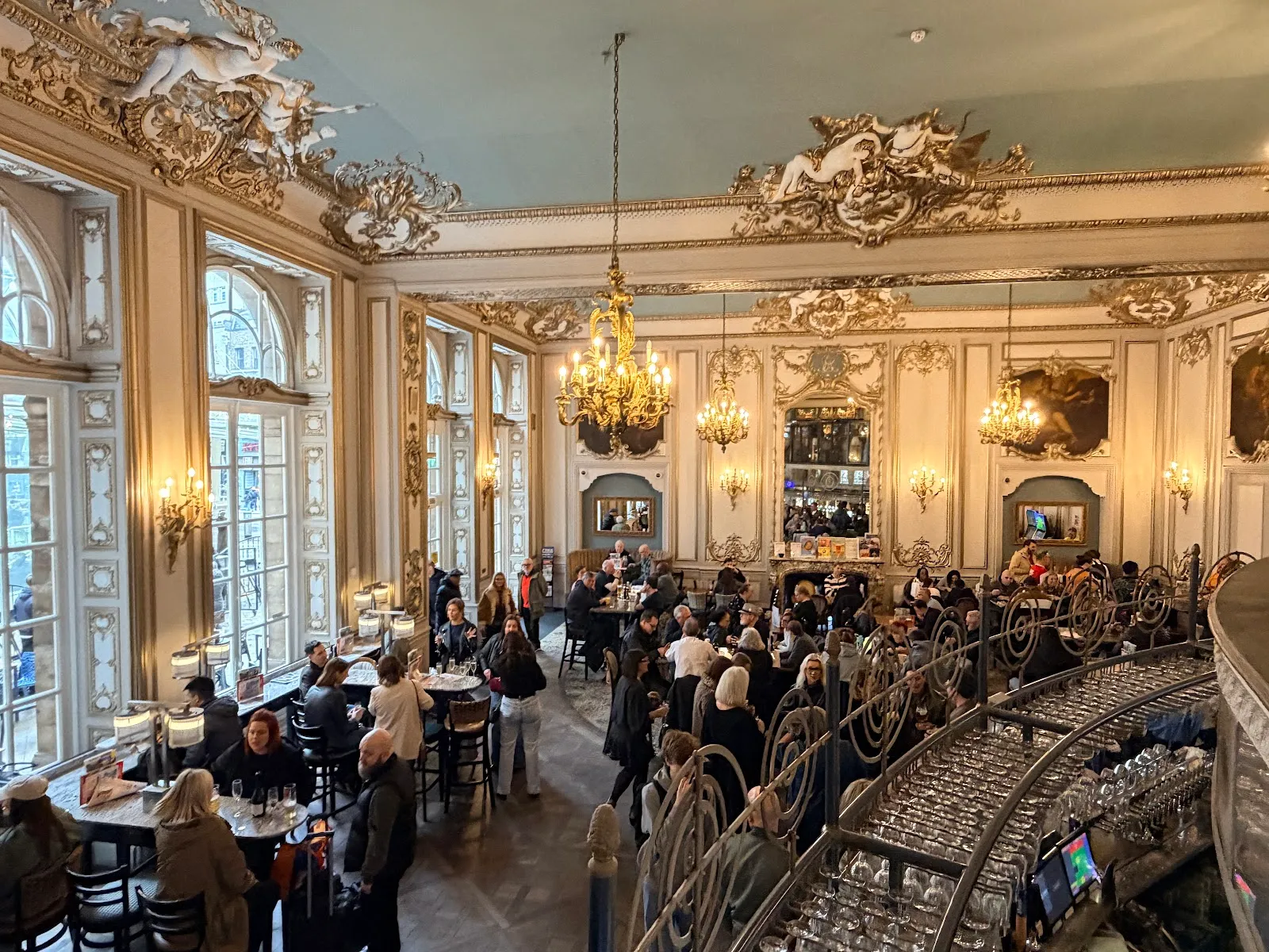The gilded ballroom ceiling and chandeliers of Hamilton Hall at Liverpool Street station