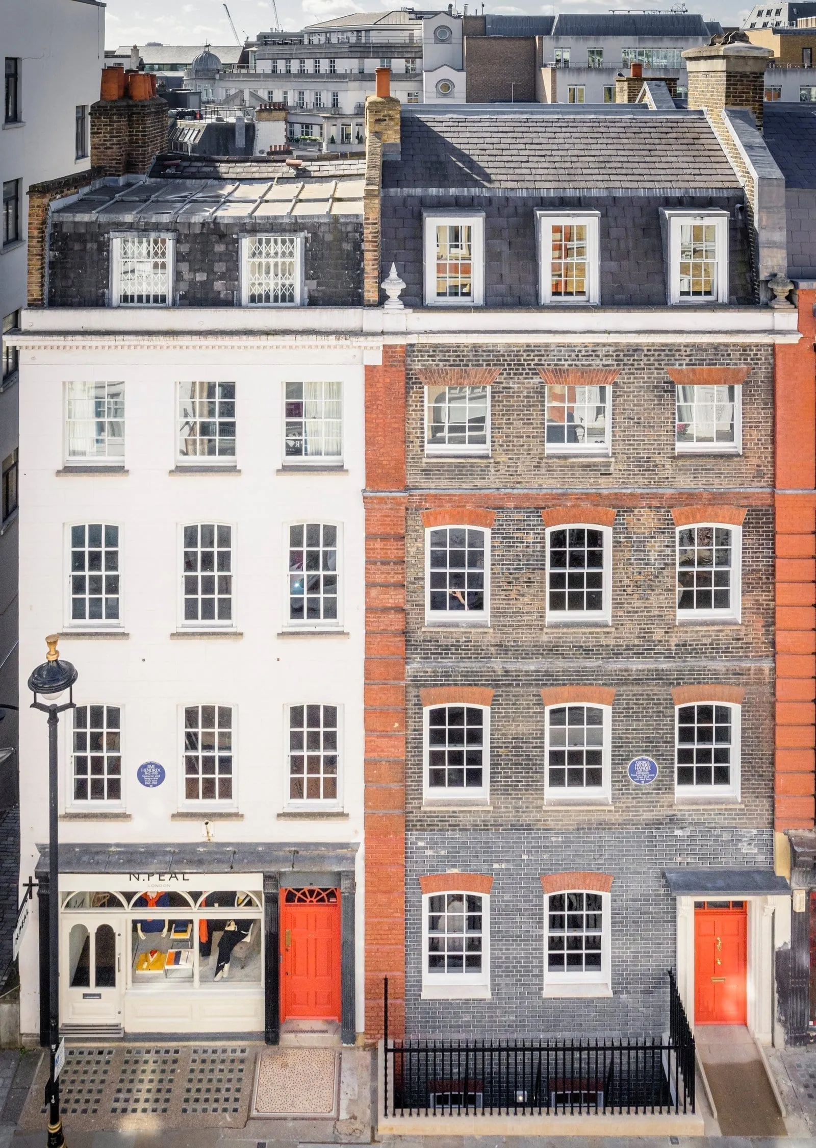Two adjoining Mayfair townhouses with blue plaques, one to Handel and one to Hendrix