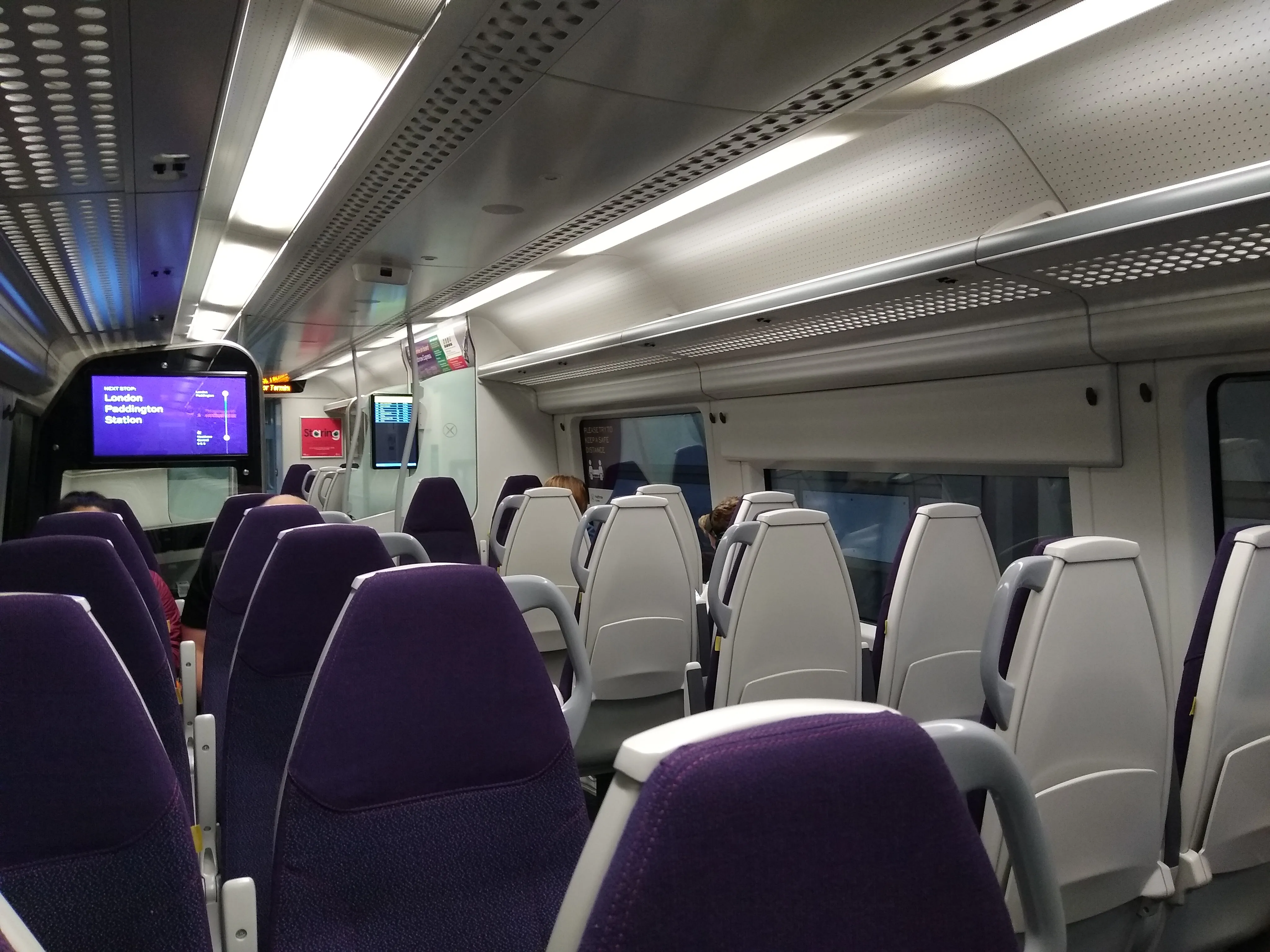 Seats and luggage space inside a Heathrow Express train.