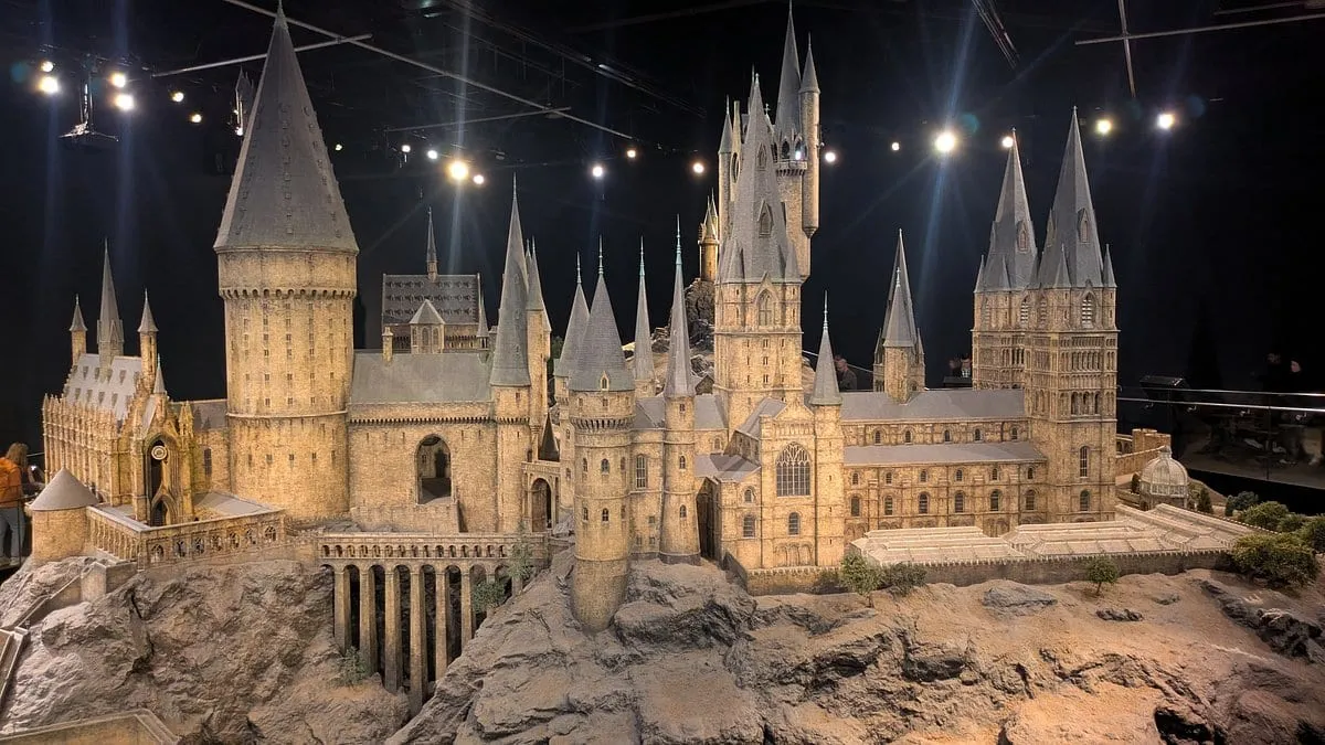 The Hogwarts castle model lit from above in the Model Room, its towers and courtyards in fine detail