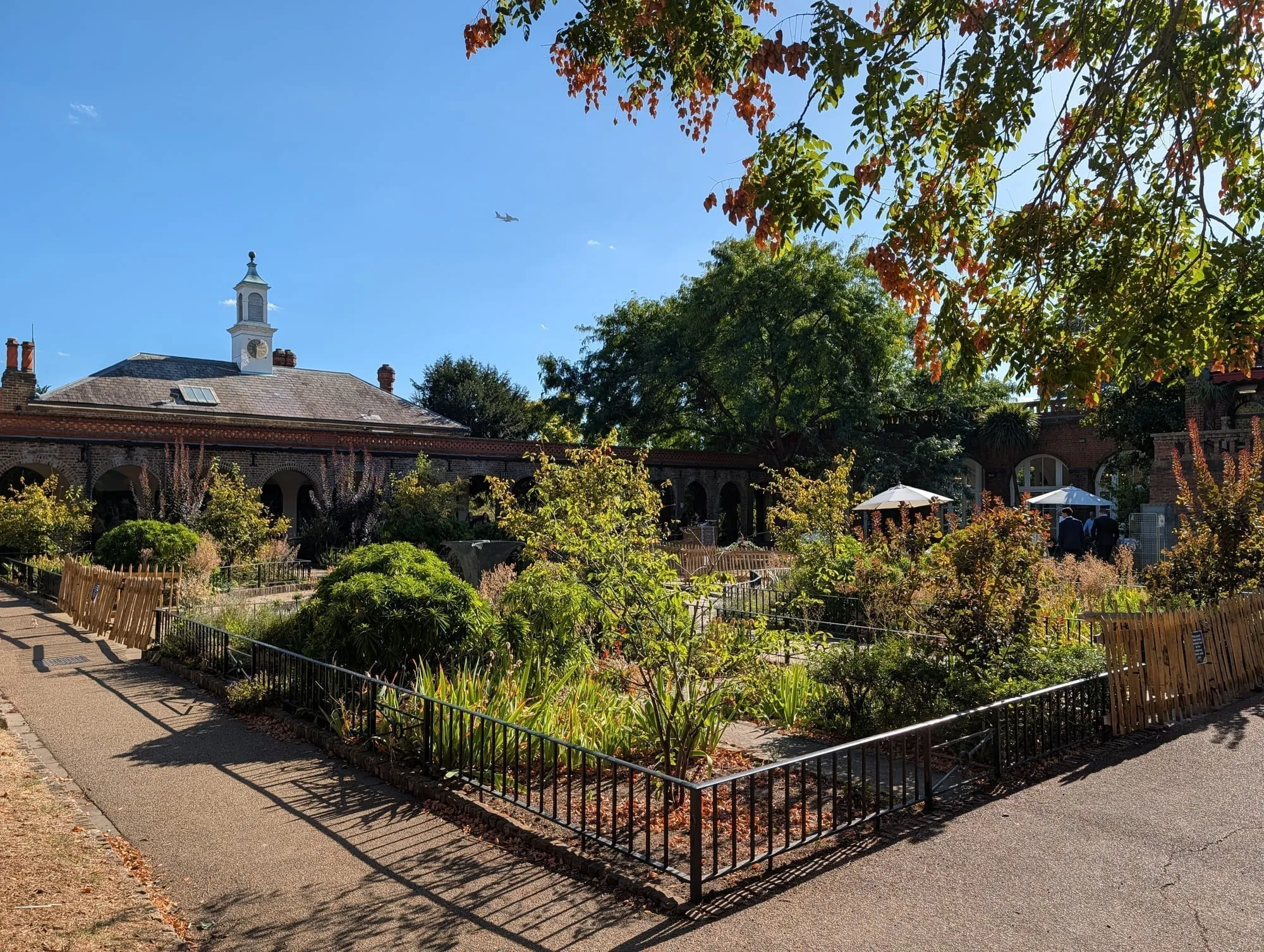The garden terrace beside the surviving wing of Holland House, with the cupola above the trees