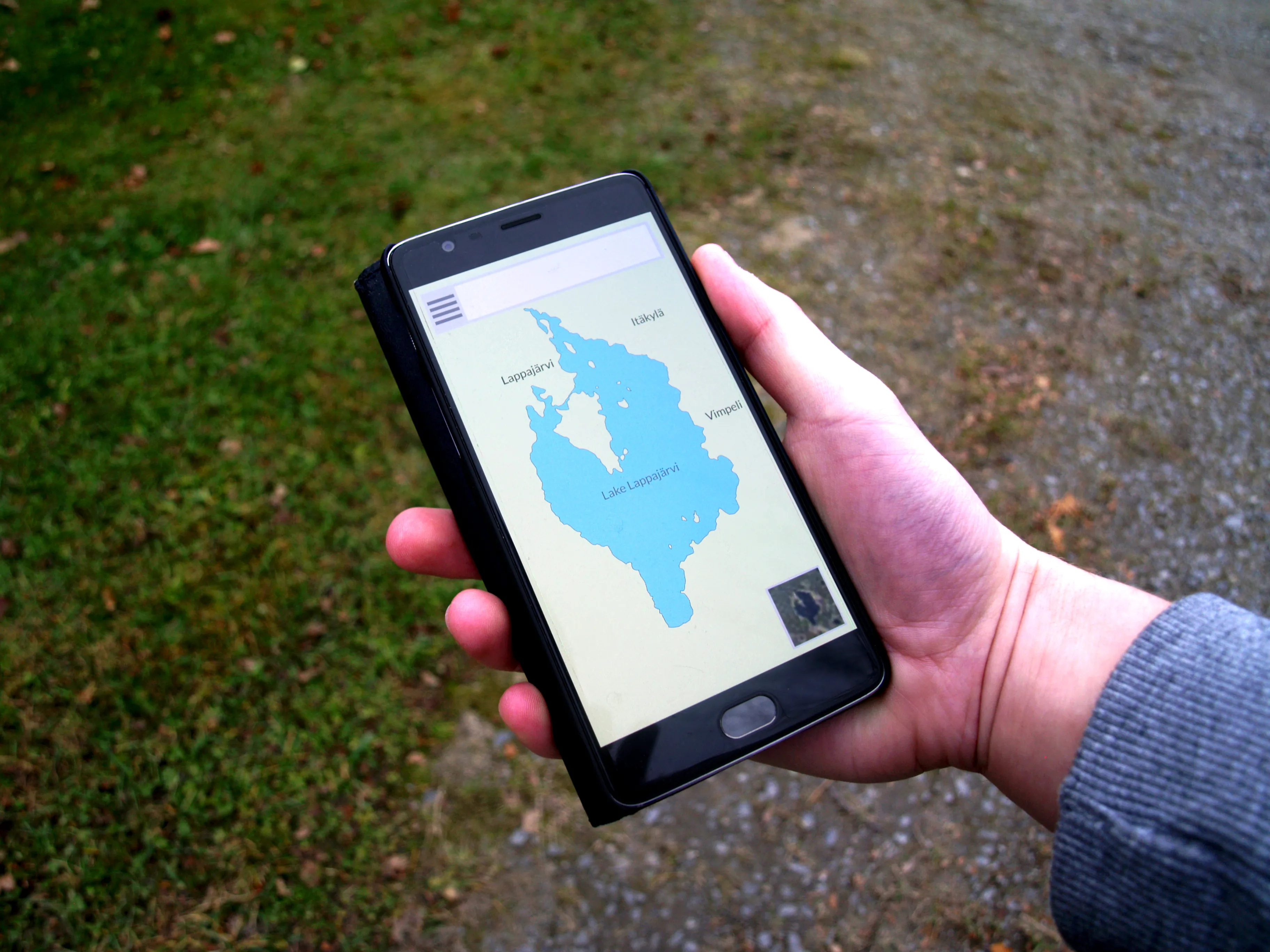 A person holding a smartphone displaying a navigation map