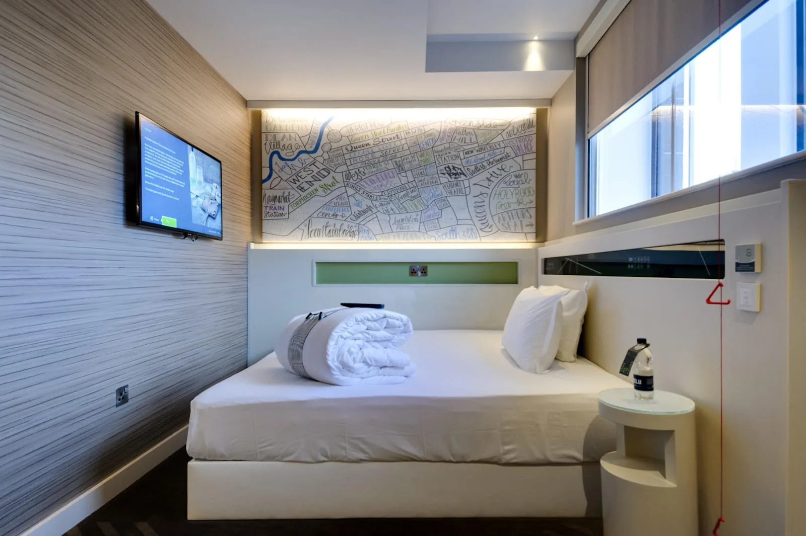 A compact room at hub by Premier Inn London Shoreditch with a double bed, a wall-mounted TV and a hand-drawn street map above the bed