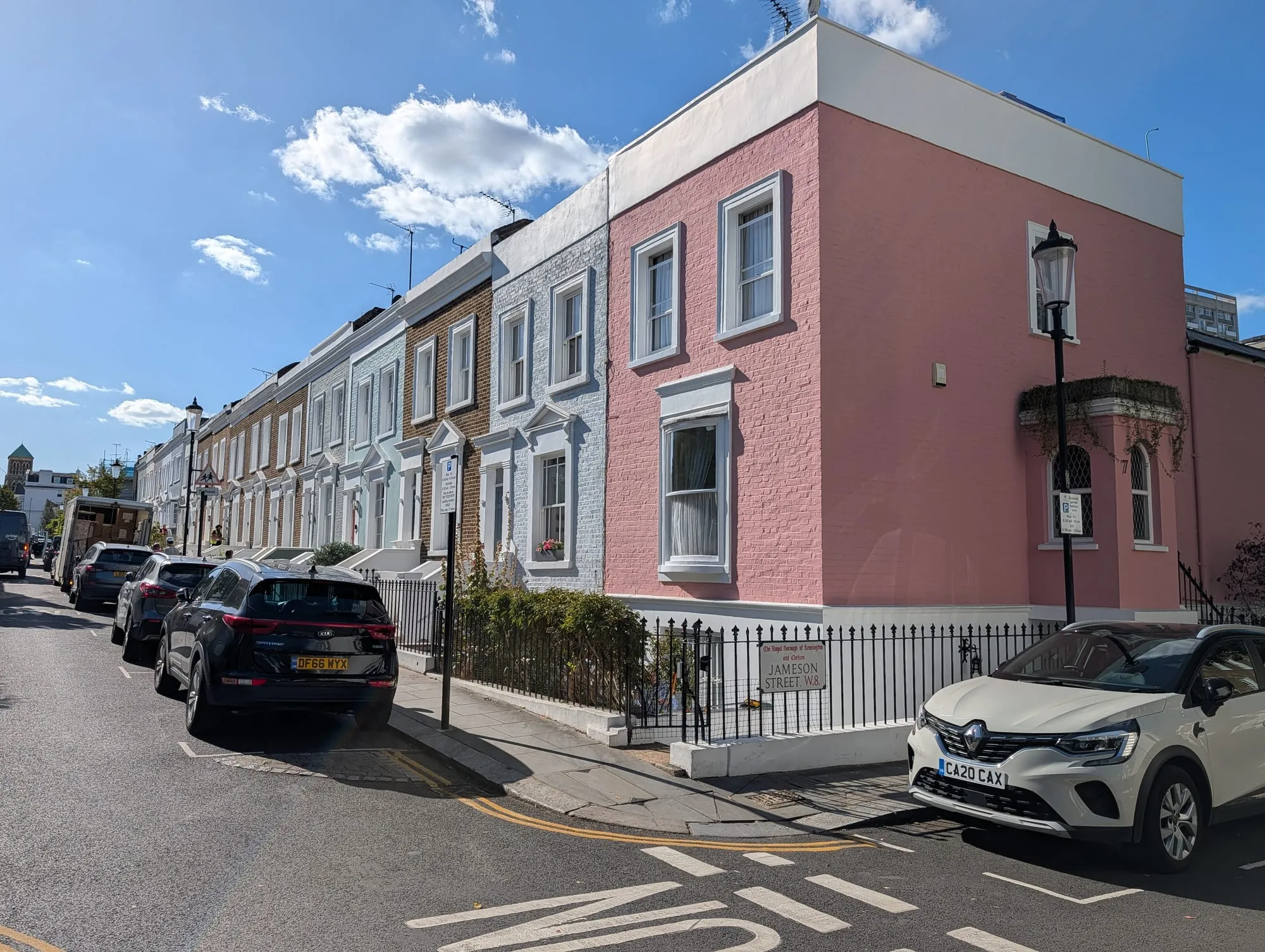 A pink corner house on Jameson Street at the end of a terrace of pastel houses