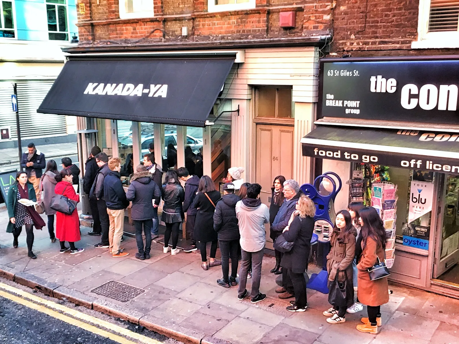 A queue stretching along the pavement outside Kanada-Ya's St Giles High Street branch