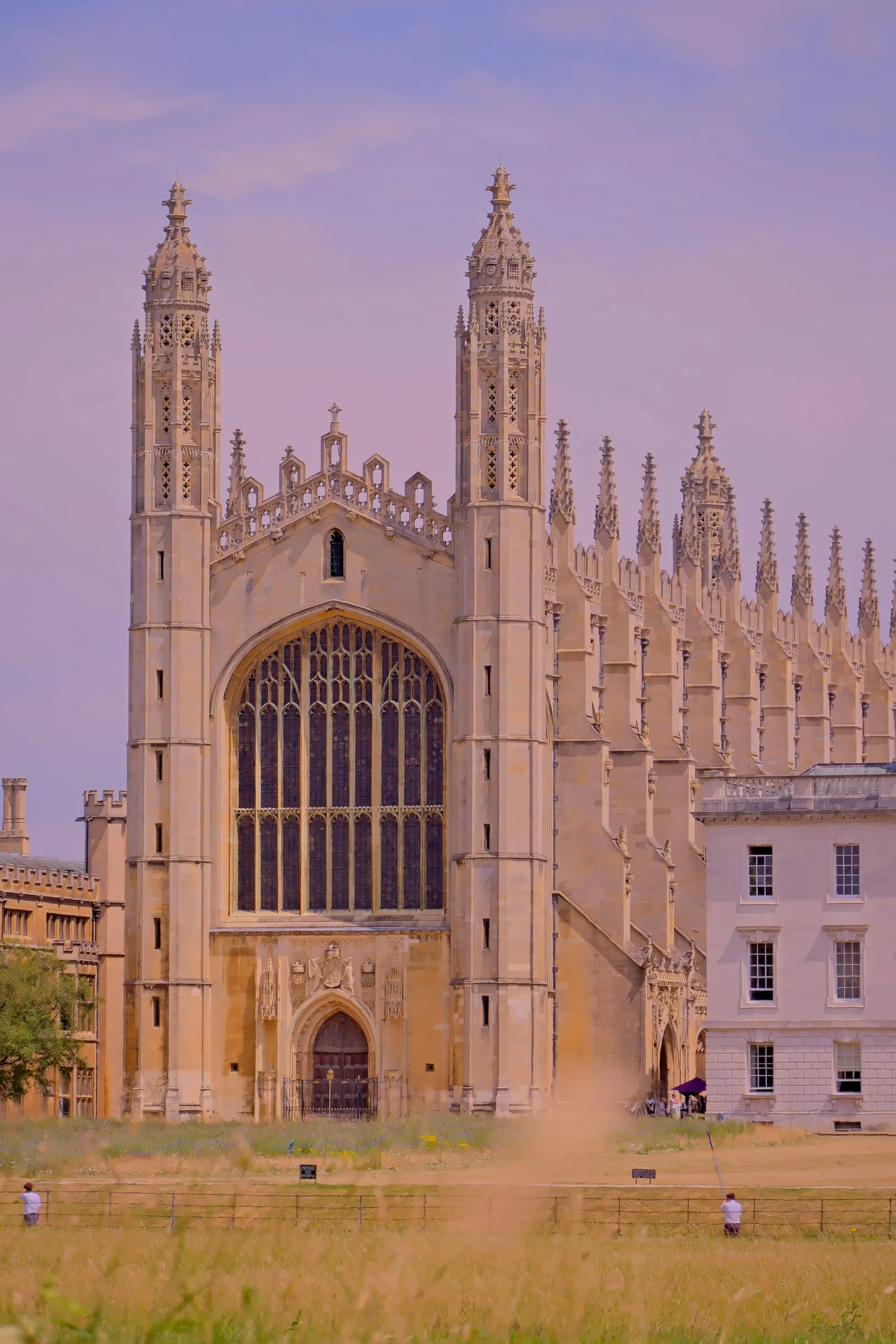 King's College Chapel in Cambridge, its pinnacles and great east window lit pink at dusk