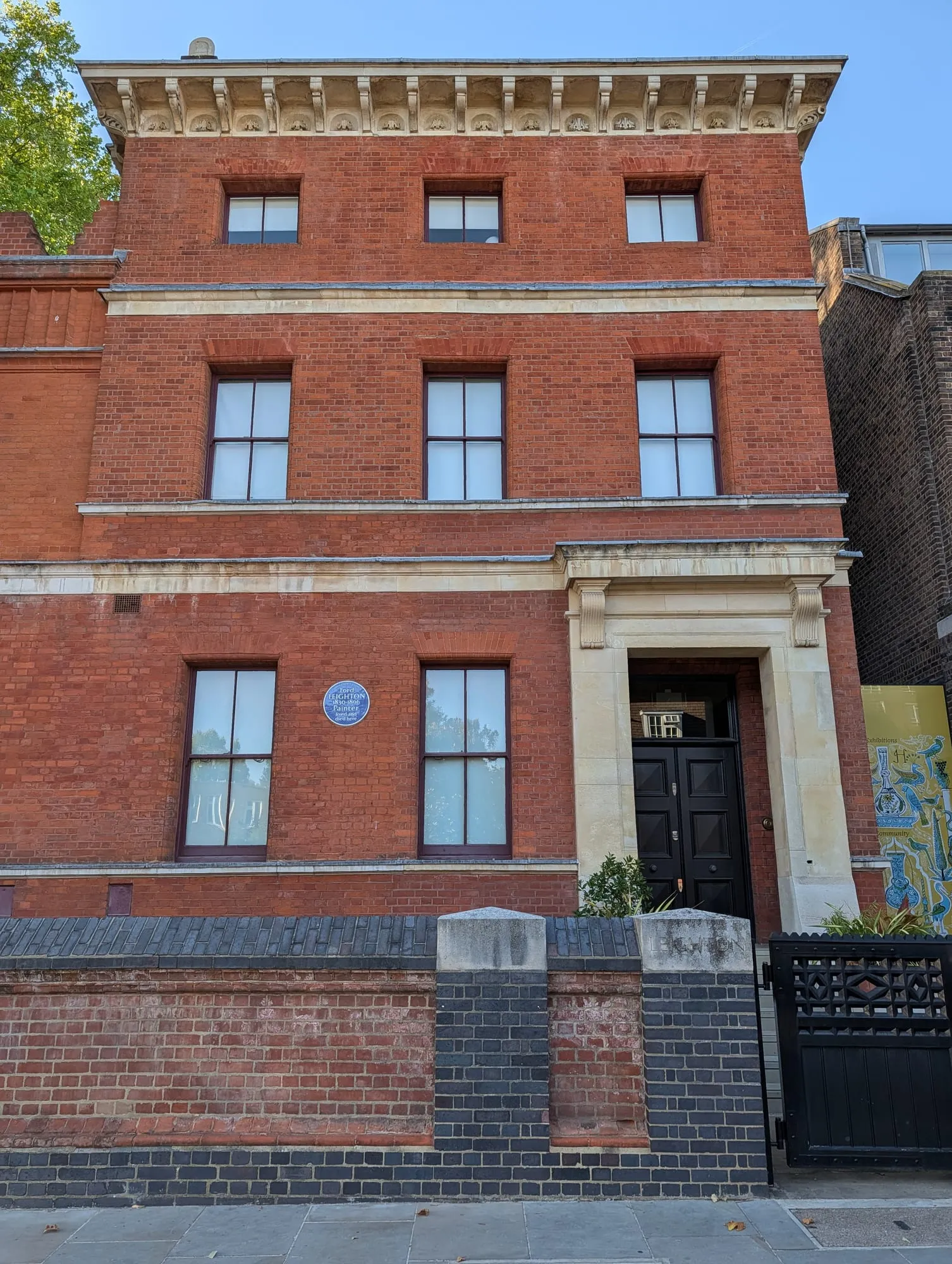 The red brick front of Leighton House on Holland Park Road, with a blue plaque to Lord Leighton between its first-floor windows