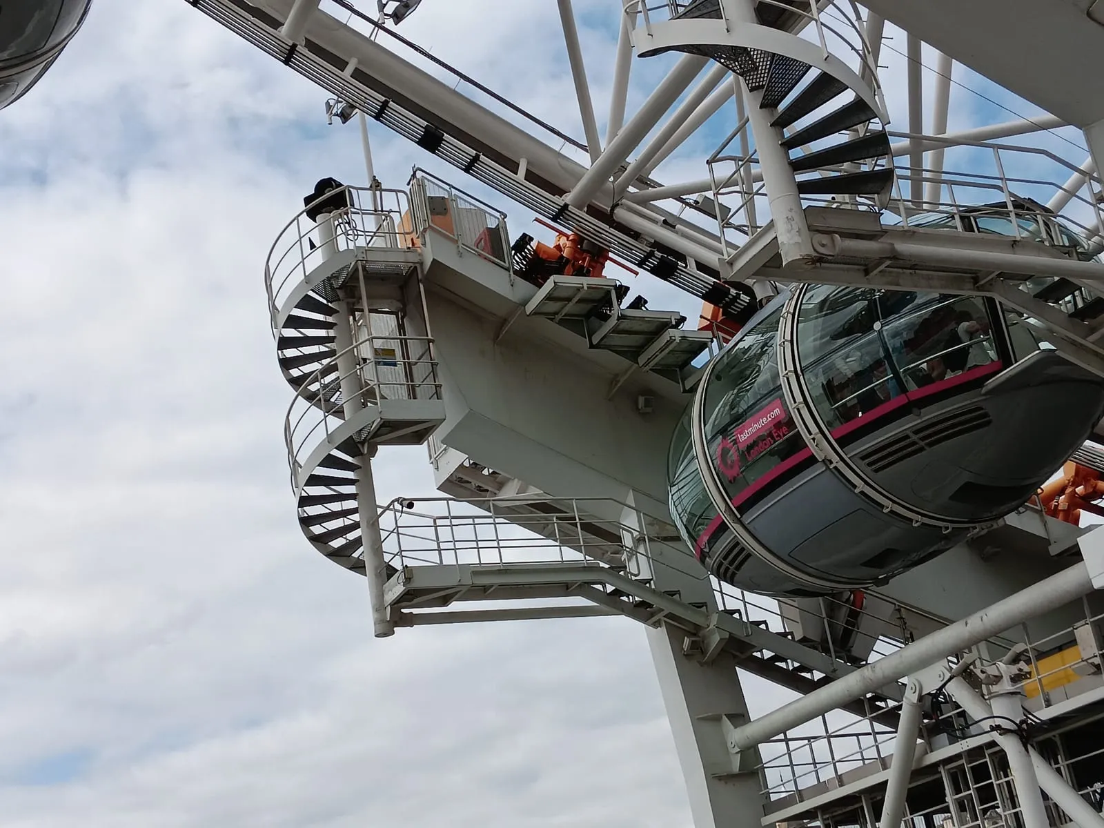 The boarding platform of the London Eye on the South Bank with visitors queueing