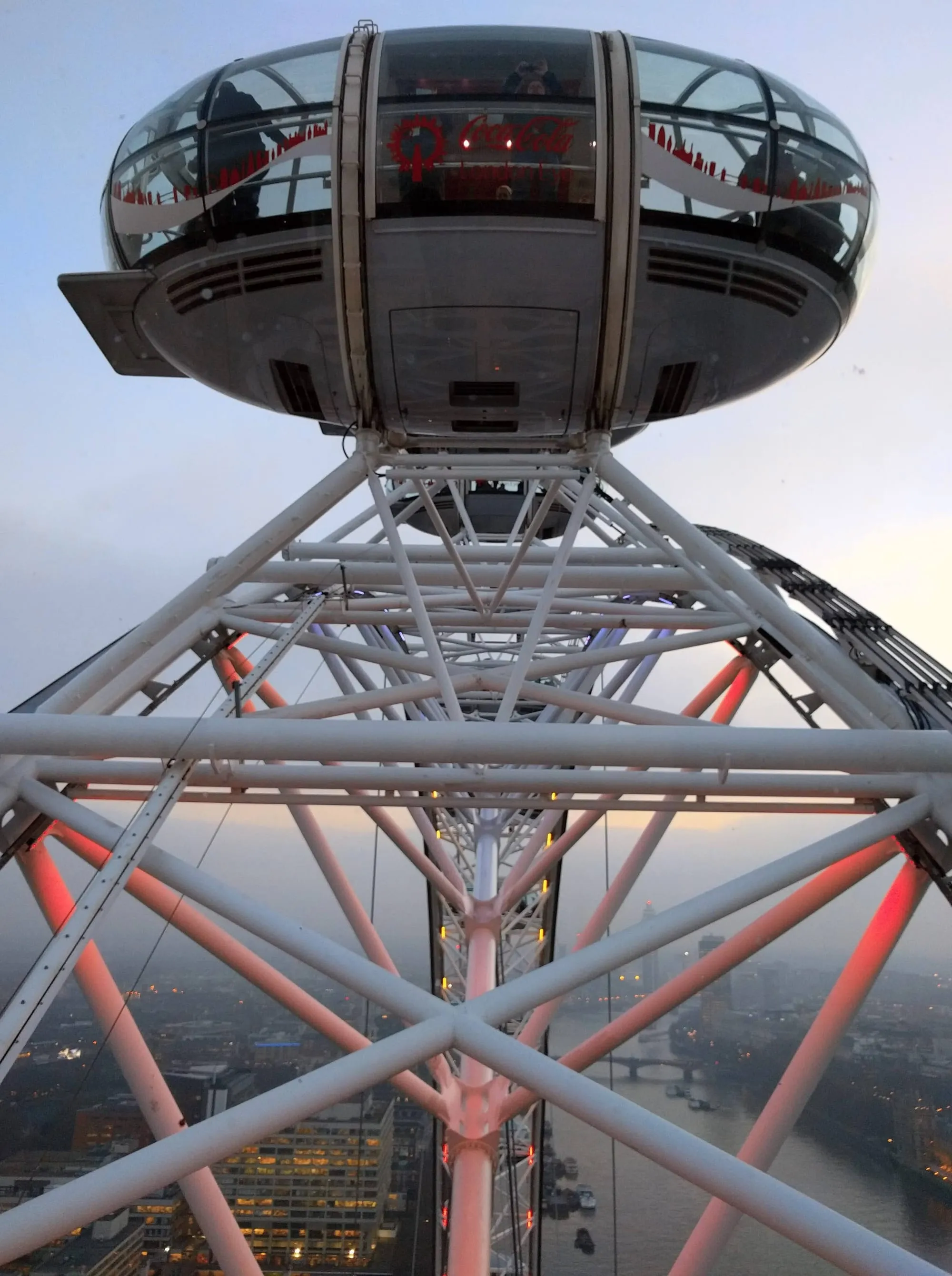The steel A-frame and capsule of the London Eye seen from directly underneath at dusk