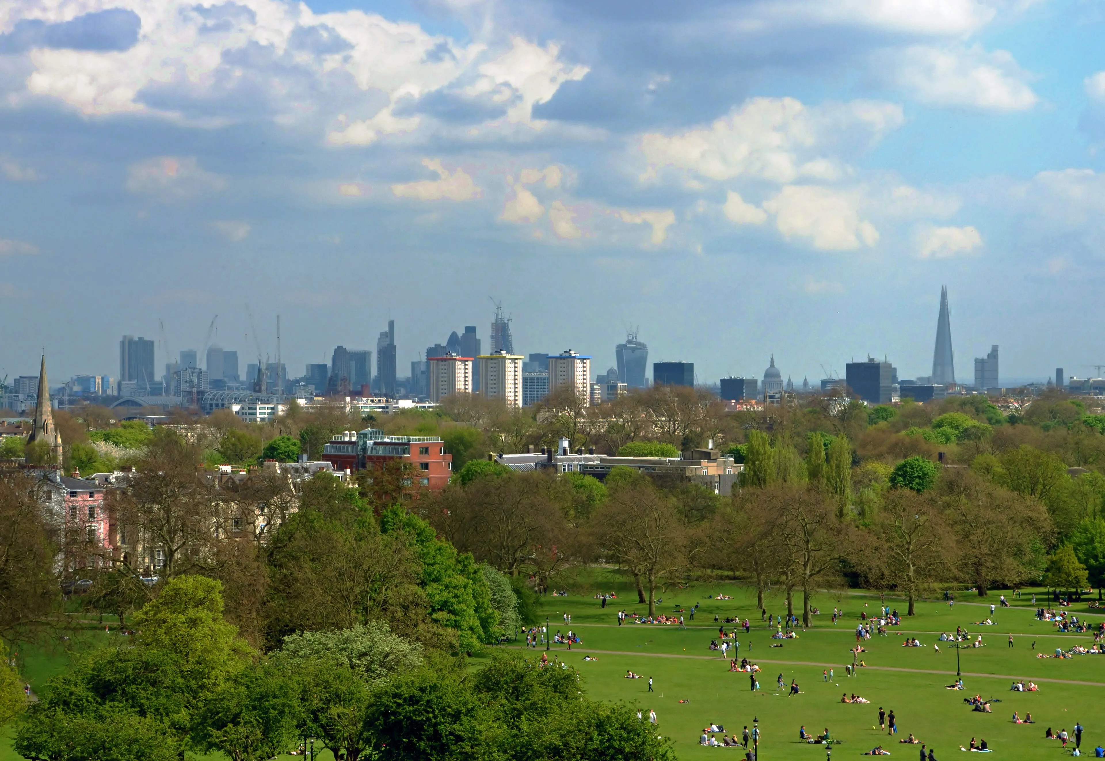 The London skyline viewed across the green slopes of Primrose Hill